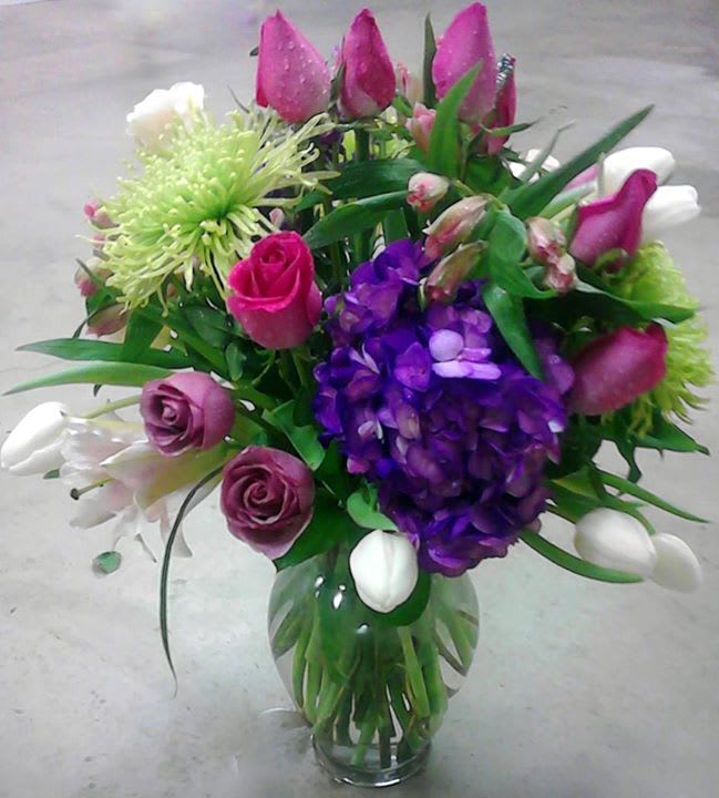 Bouquet of pink, purple, and white flowers in a glass vase
