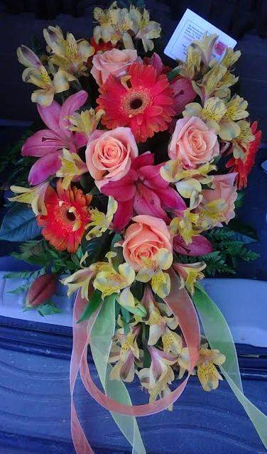 Bouquet of pink roses, gerbera daisies, and alstroemeria with ribbon tails