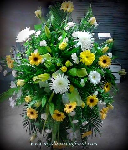 Large standing floral spray with yellow and white daisies