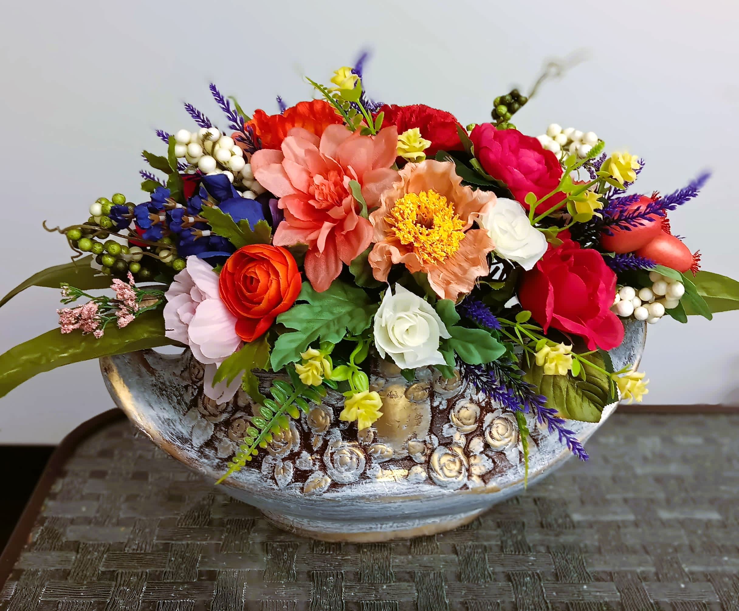 Colorful mixed flower arrangement in a decorative ceramic bowl