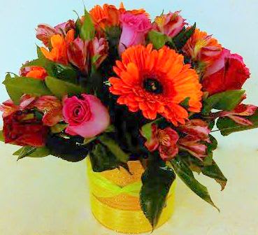Bouquet of orange and pink flowers in a yellow vase