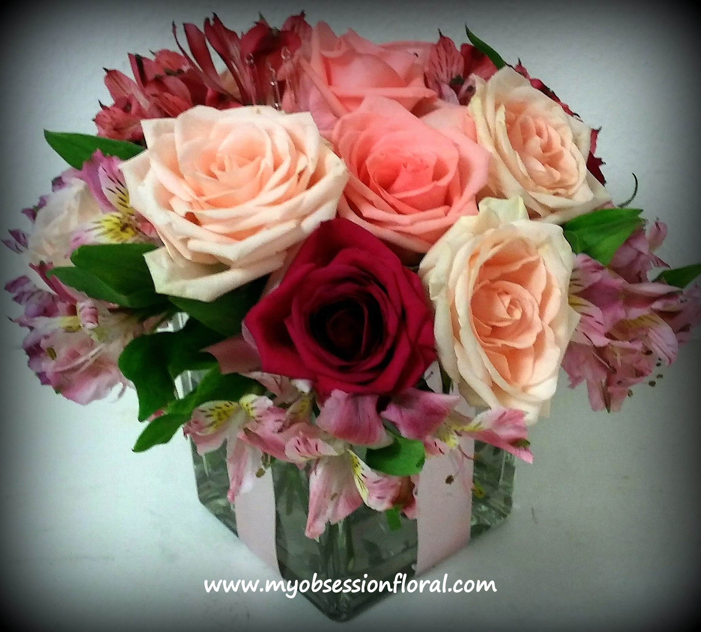 Bouquet of pink and peach roses in a glass vase