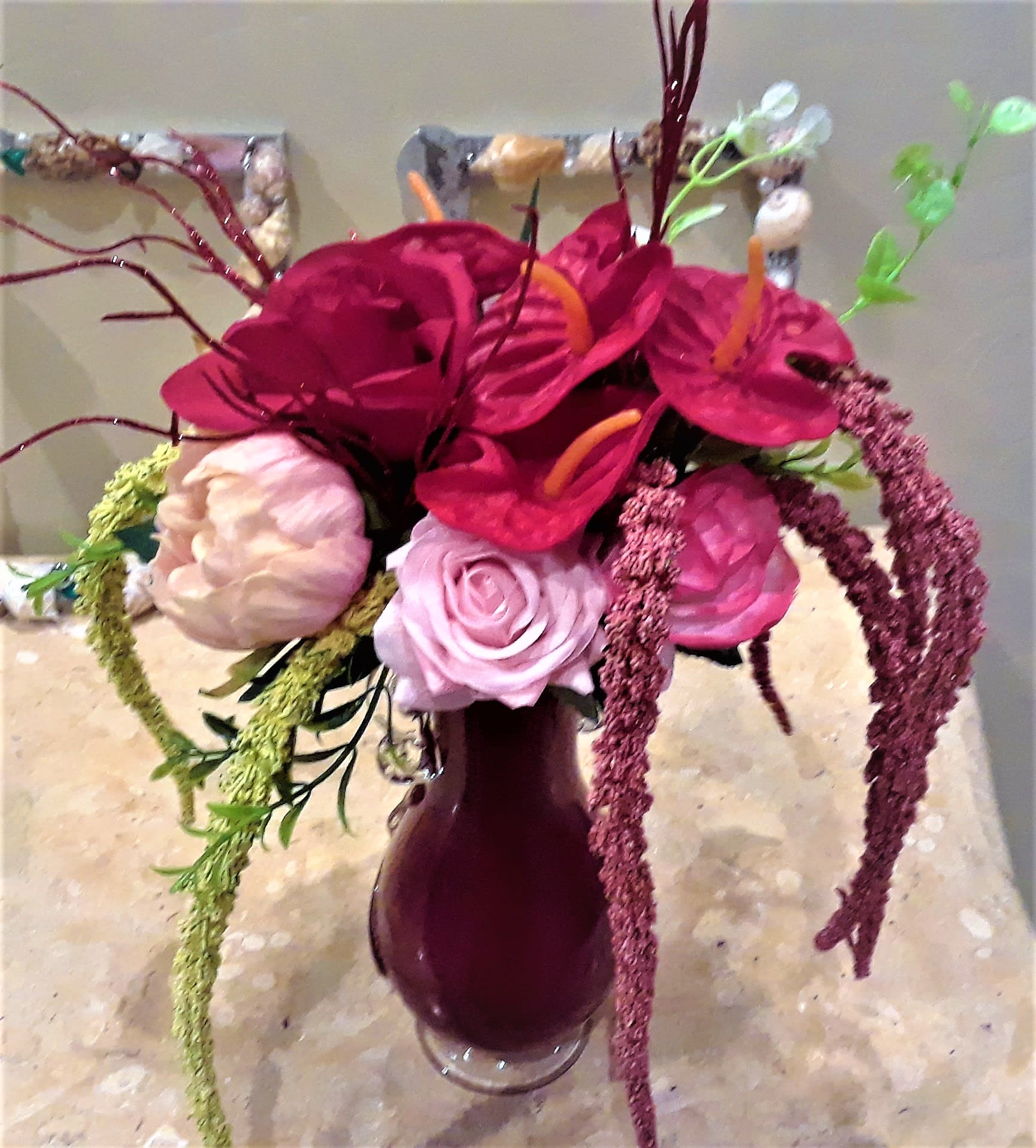 Bouquet of magenta and pink flowers in a dark vase
