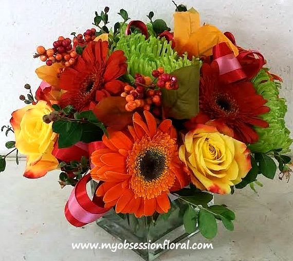 Bouquet of orange gerbera daisies and yellow roses with ribbon