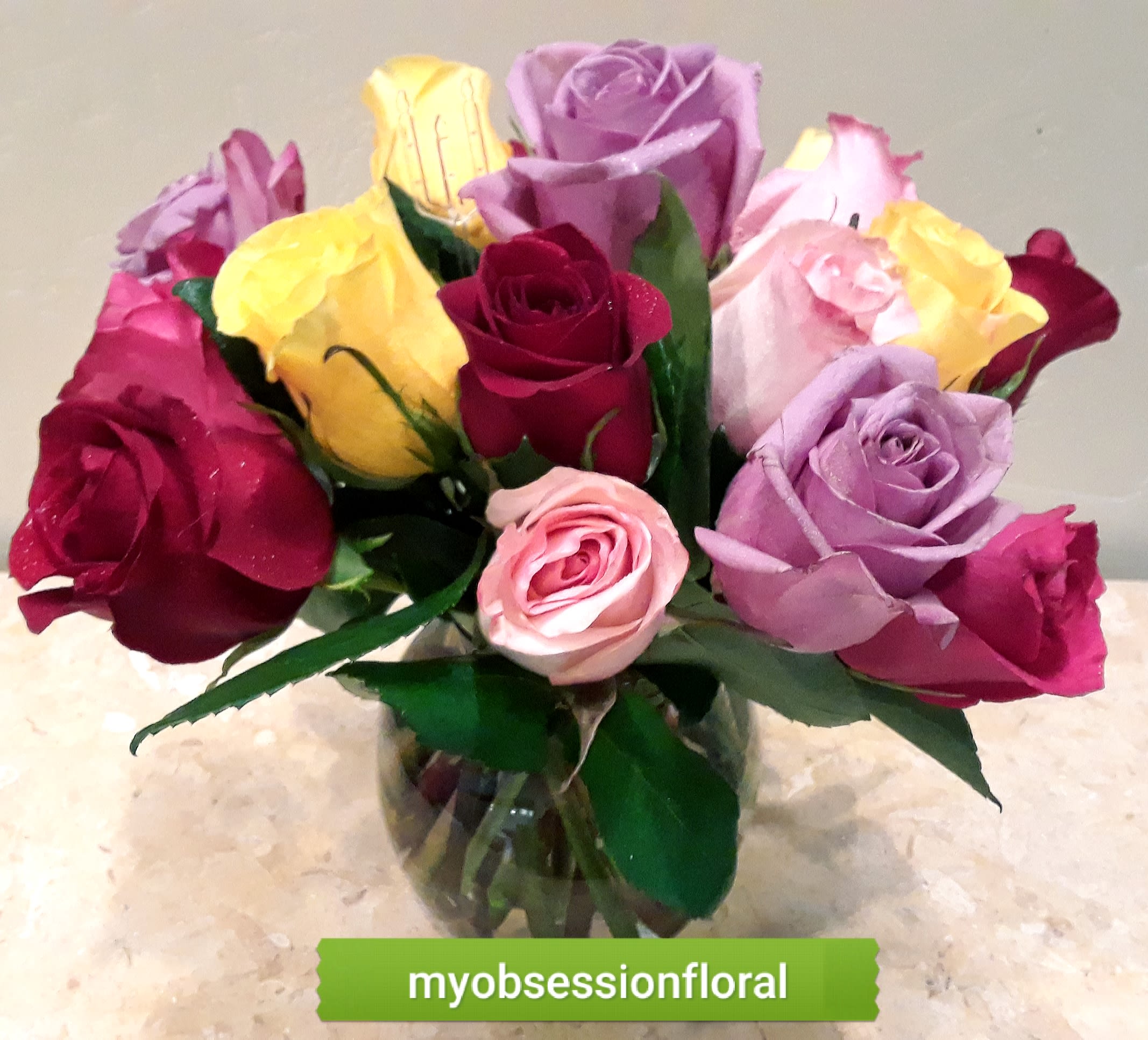 Bouquet of multicolored roses in a glass vase