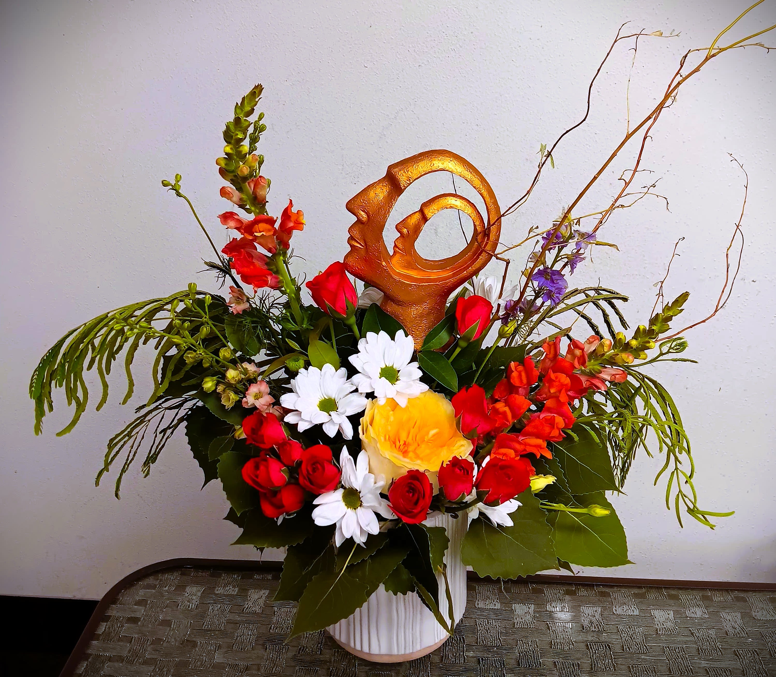 Mixed bouquet in a white vase with red, white, and yellow flowers