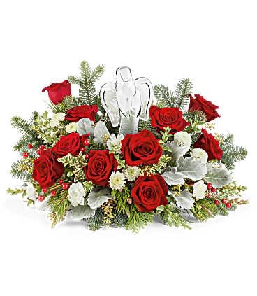 Red roses with white accents and an angel ornament