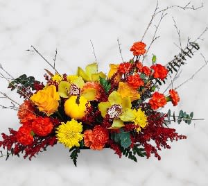 Bright mixed floral arrangement with yellow, orange, and red blooms