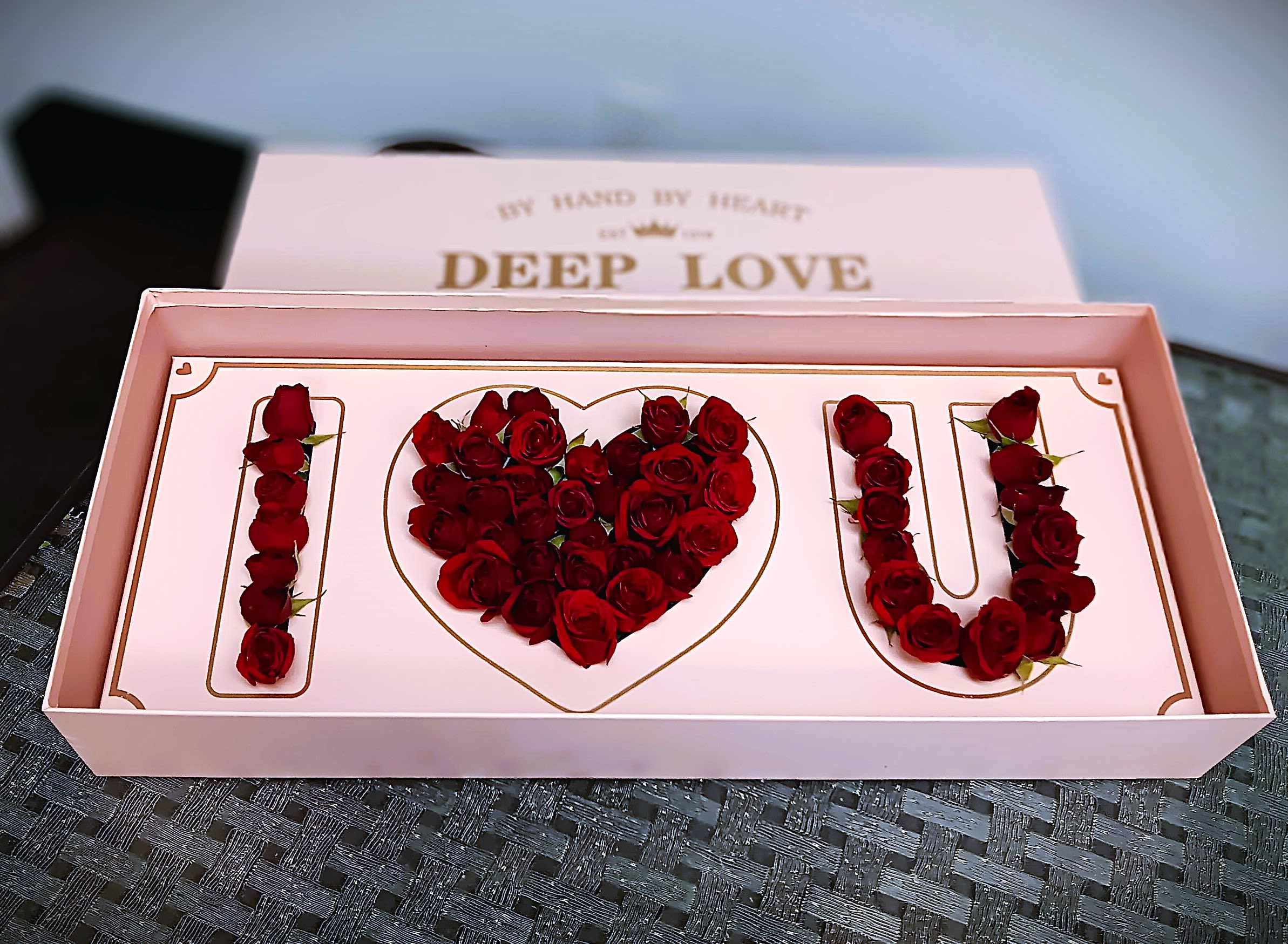 Pink gift box with red roses arranged as "I love U"