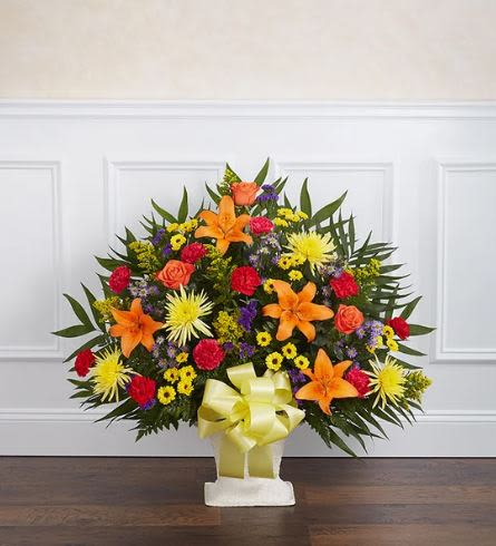Heartfelt Tribute Bright Floor Basket  - Pet Friendly? No. This arrangement contains Asiatic Lilies, which are highly toxic to cats and can cause kidney failure even in small amounts.  Keep this arrangement strictly out of reach of animals and avoid sending it to homes with curious cats.   Human Allergy Note : This arrangement contains Lilies, Solidago, and Mums, all of which are known to be pollen-heavy.  To reduce irritation, keep the room well-ventilated and avoid placing the basket near bedding or high-traffic seating areas.   Care &amp; Longevity : Because this arrangement is set in floral foam within a basket, it requires consistent hydration. Gently pour fresh water into the center of the container daily to keep the foam saturated. Avoid placing the basket near heating vents, direct sunlight, or drafty doors.    Best Occasions &amp; Situations : - Funeral or Memorial Service - Church Alter Display - Celebration of Life - Graveside Service - Large Home Entrance Tribute - Corporate Sympathy Gesture  Why Customers Love It : - High Visibility: The tall, fan-shaped design ensures the tribute is seen clearly from the back of a chapel or church. - Vibrant Energy: The bold orange and yellow tones offer a celebratory feel rather than a somber one. - Ready-to-Display: Comes in a stable floor basket with a decorative bow, requiring no additional setup. - Long-Lasting Blooms: Features sturdy varieties like Carnations and Mums for extended display life.