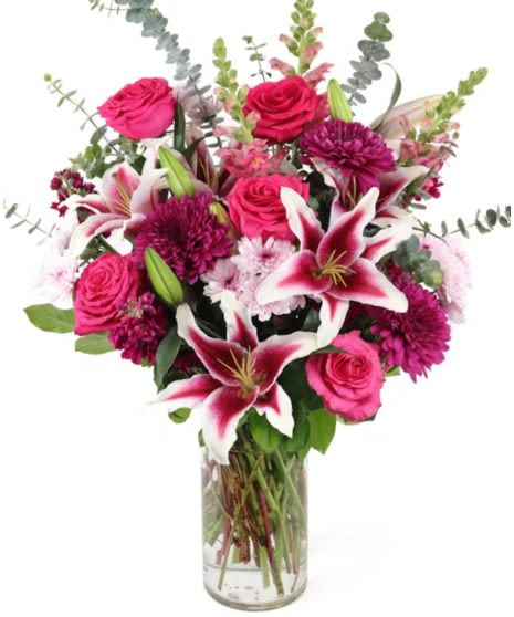 Pink roses and lilies in a clear glass vase