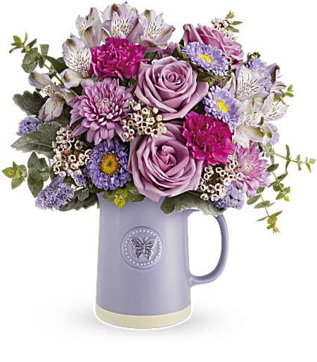 Lavender and pink mixed bouquet in a purple pitcher vase