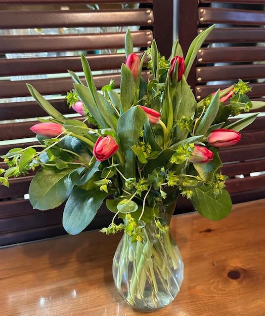 Pink tulips arranged in a clear glass vase