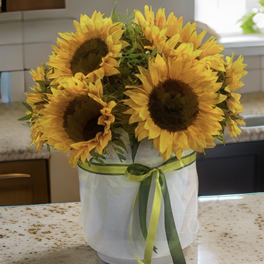 Sunflower bouquet in a white wrapped container with green ribbon