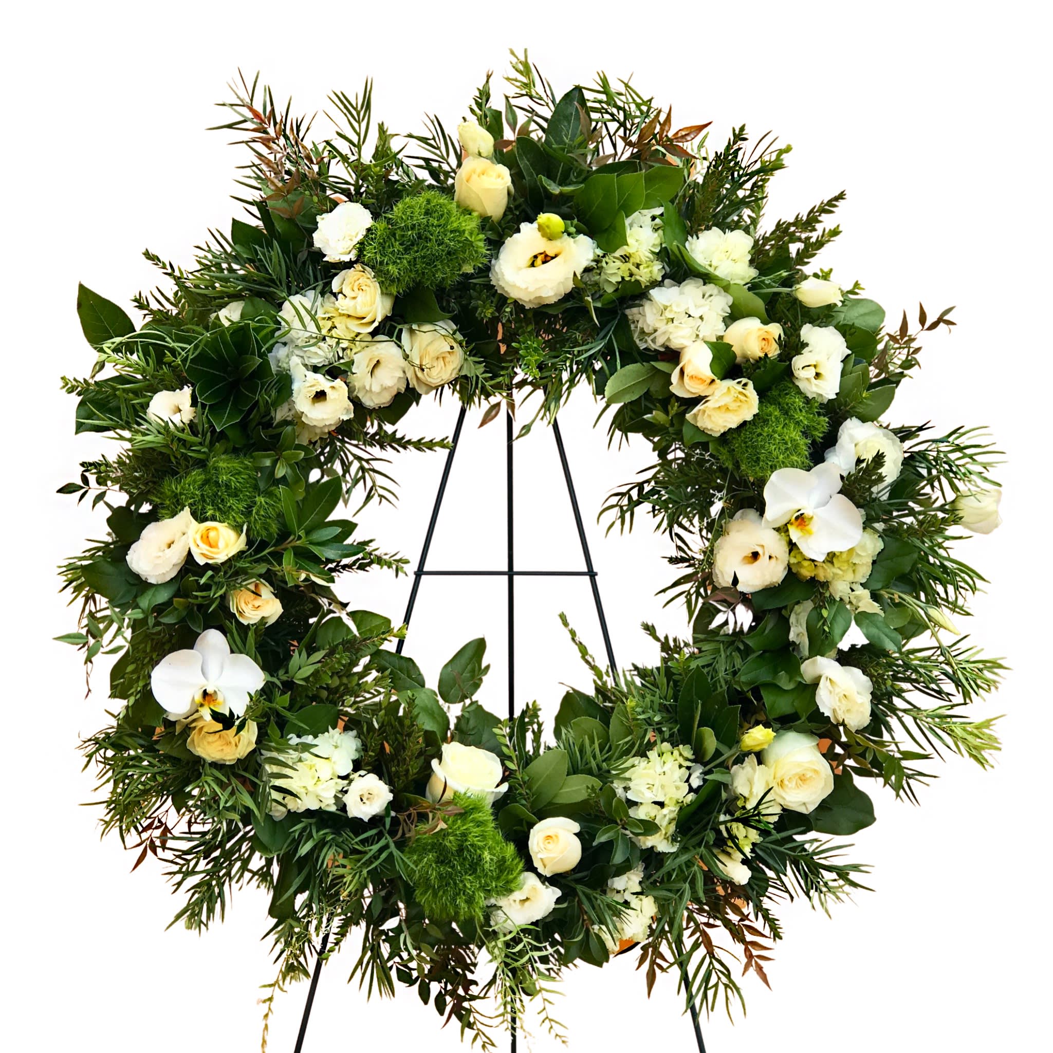 Large floral wreath with white roses and orchids on a black stand