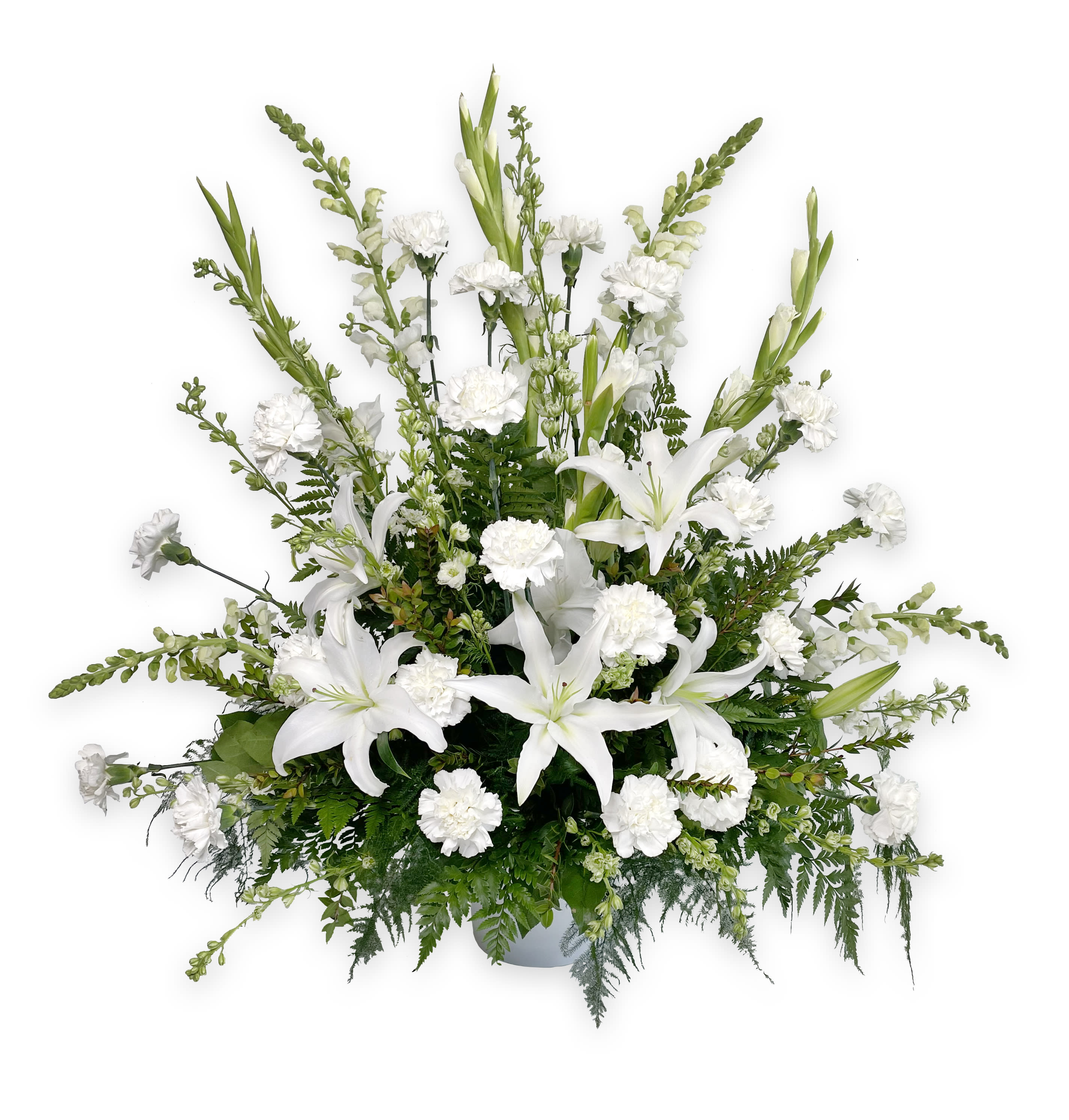 White lilies and carnations in a low vase arrangement