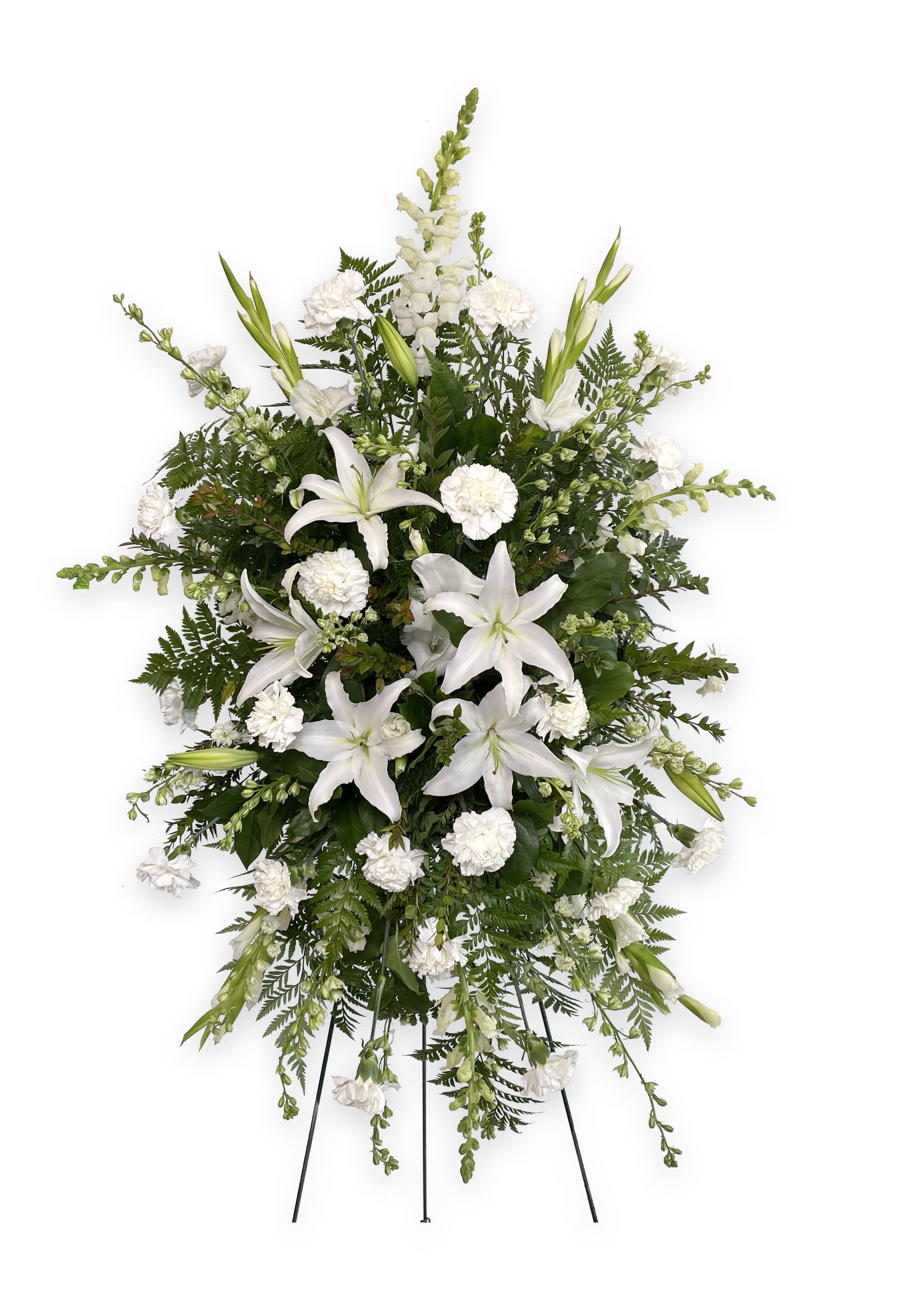 White lilies and carnations in a standing spray on an easel