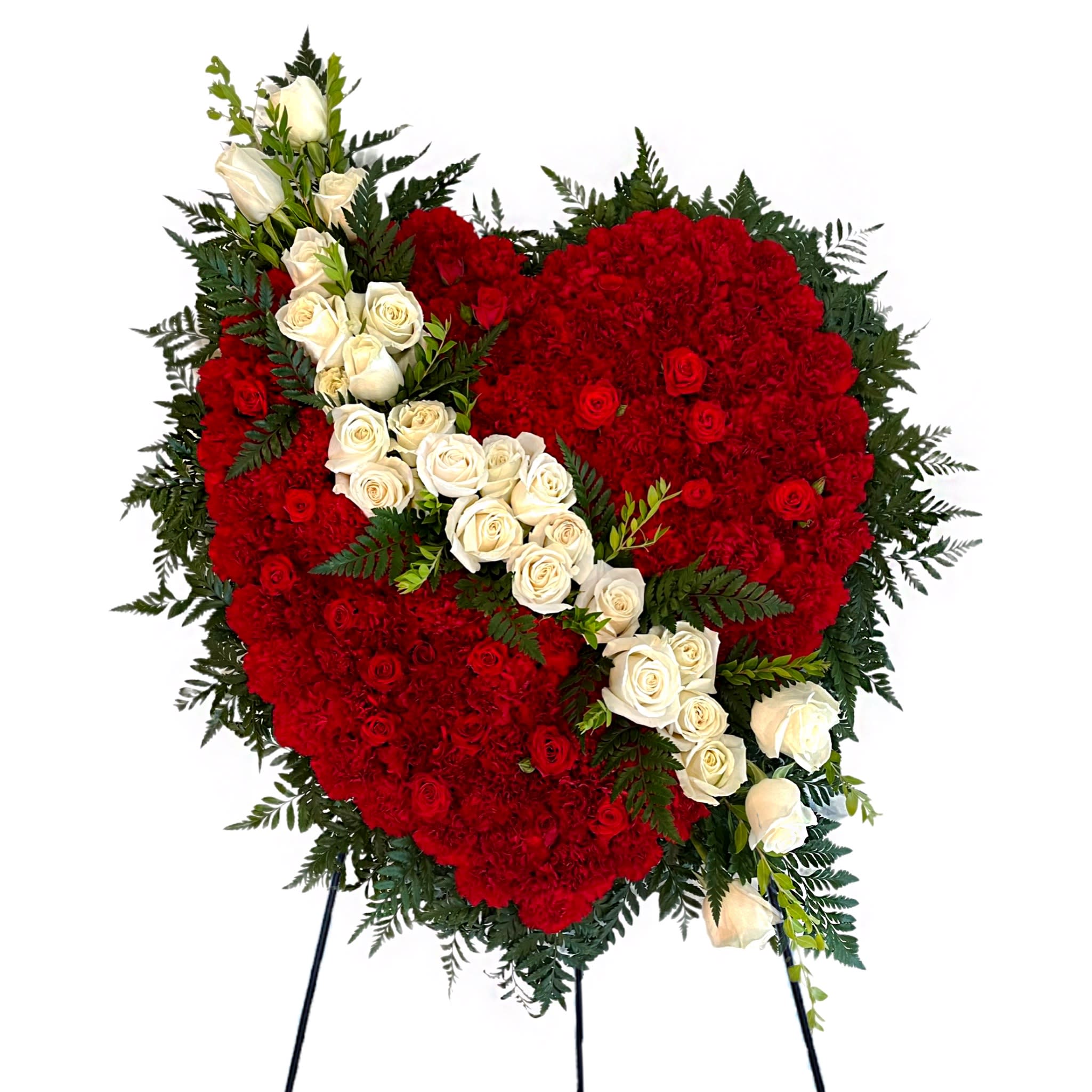 Heart-shaped red floral spray with white roses on a stand
