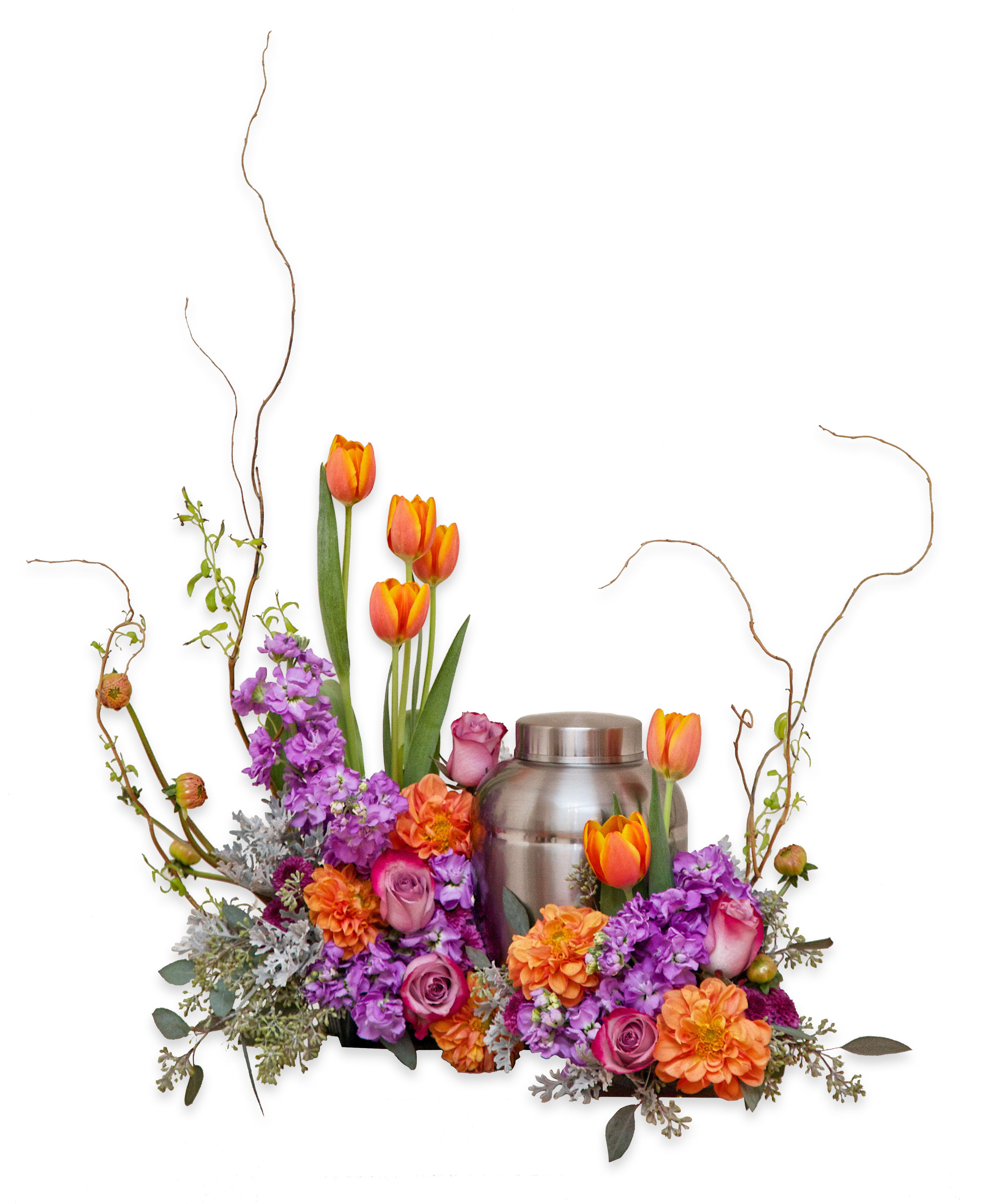 Orange tulips and purple flowers arranged around a silver urn