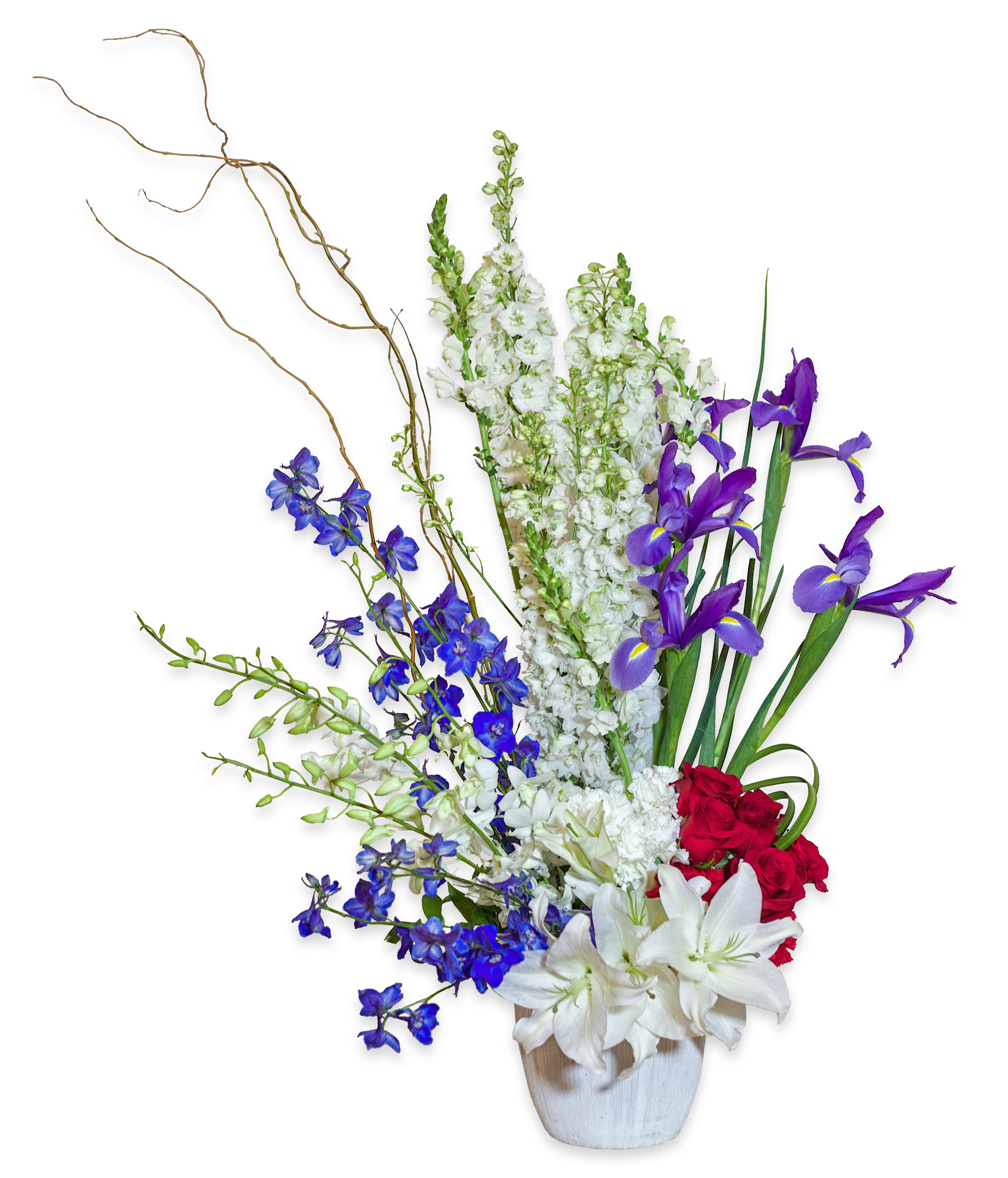 Tall floral arrangement with white lilies, purple irises, and red roses in a white vase