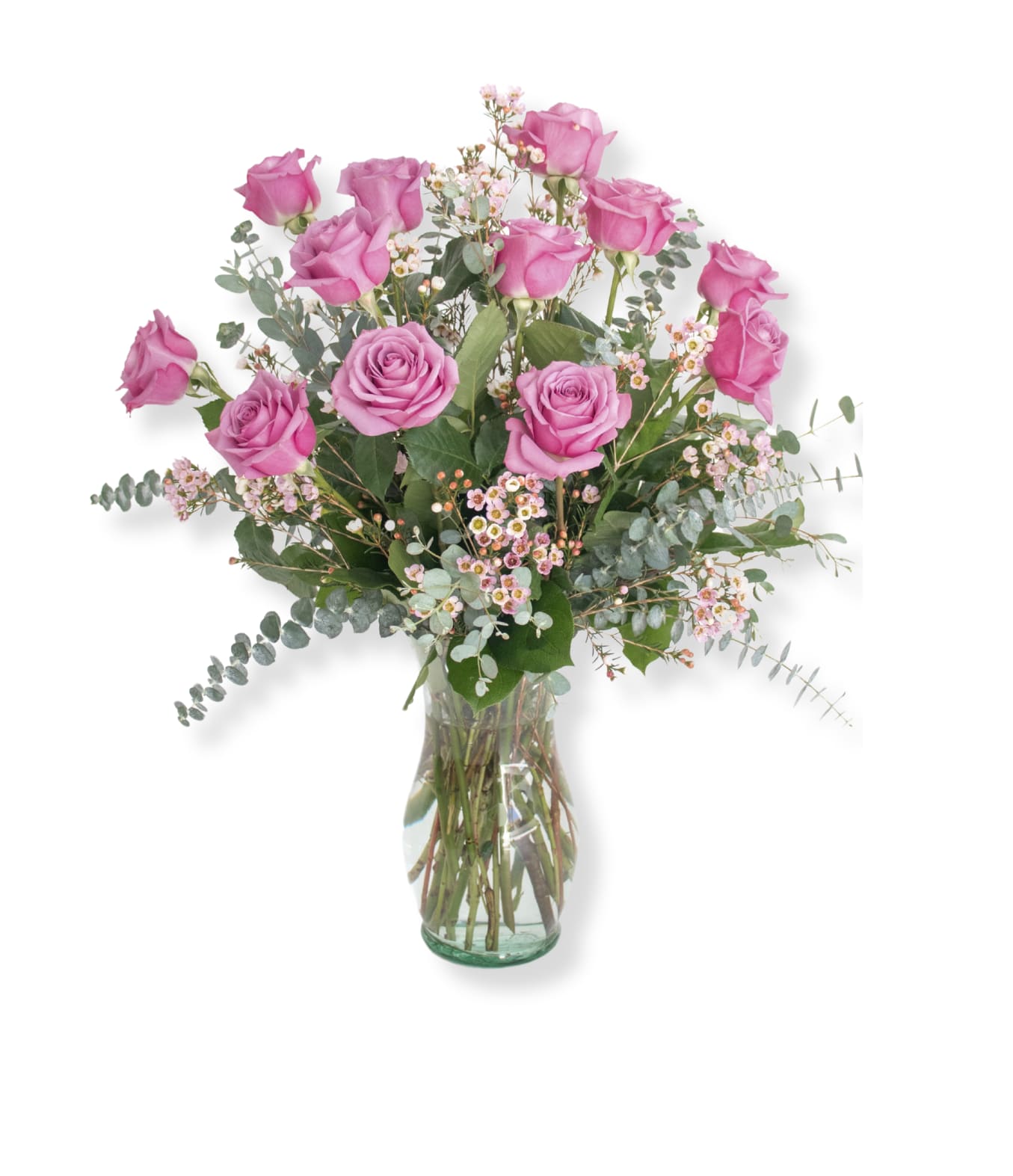 Pink roses arranged in a clear glass vase with airy filler flowers