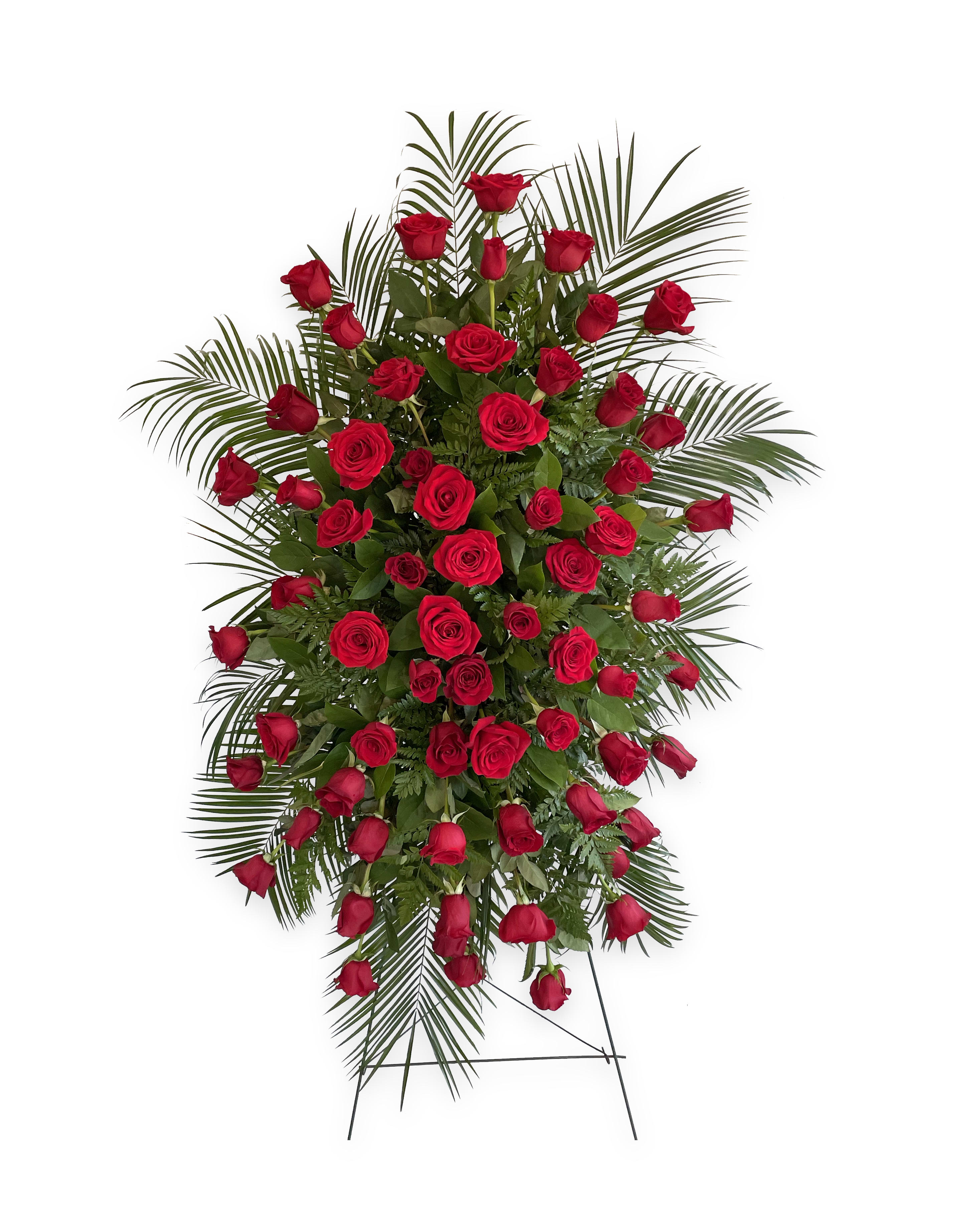 Standing spray of red roses with palm fronds on a wire easel