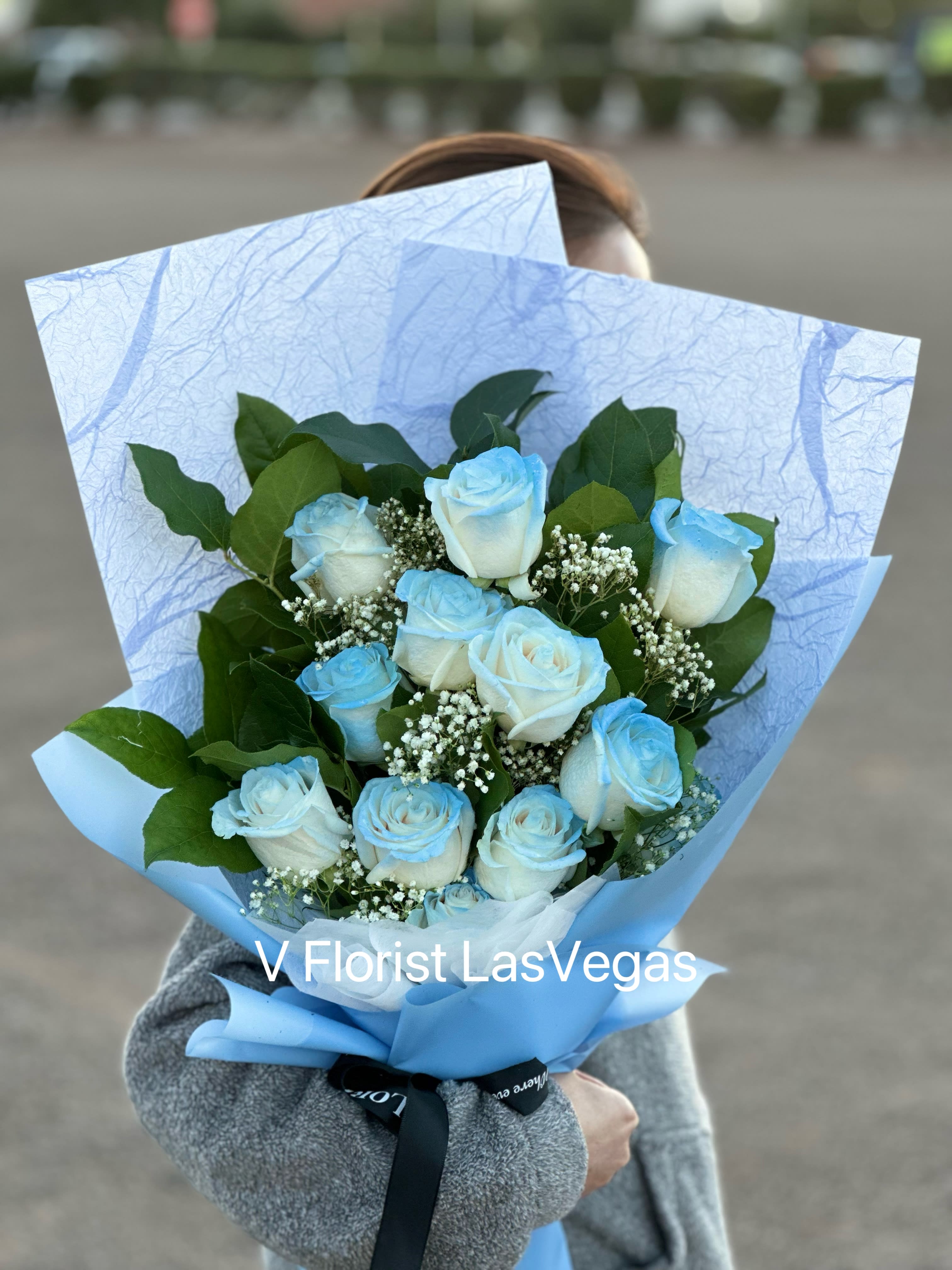 Bouquet of light blue and white roses with baby's breath