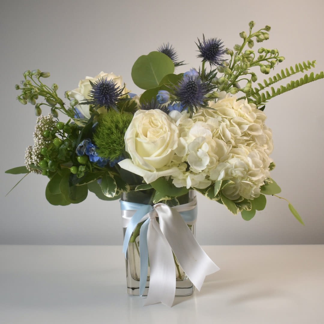 Welcome Baby | Deluxe Blue - Each arrangement is custom designed, using seasonal, best-of-day blooms. The image shown represents its size, style and temperament, however certain flowers may be substituted to achieve the best quality and longevity for your florals.