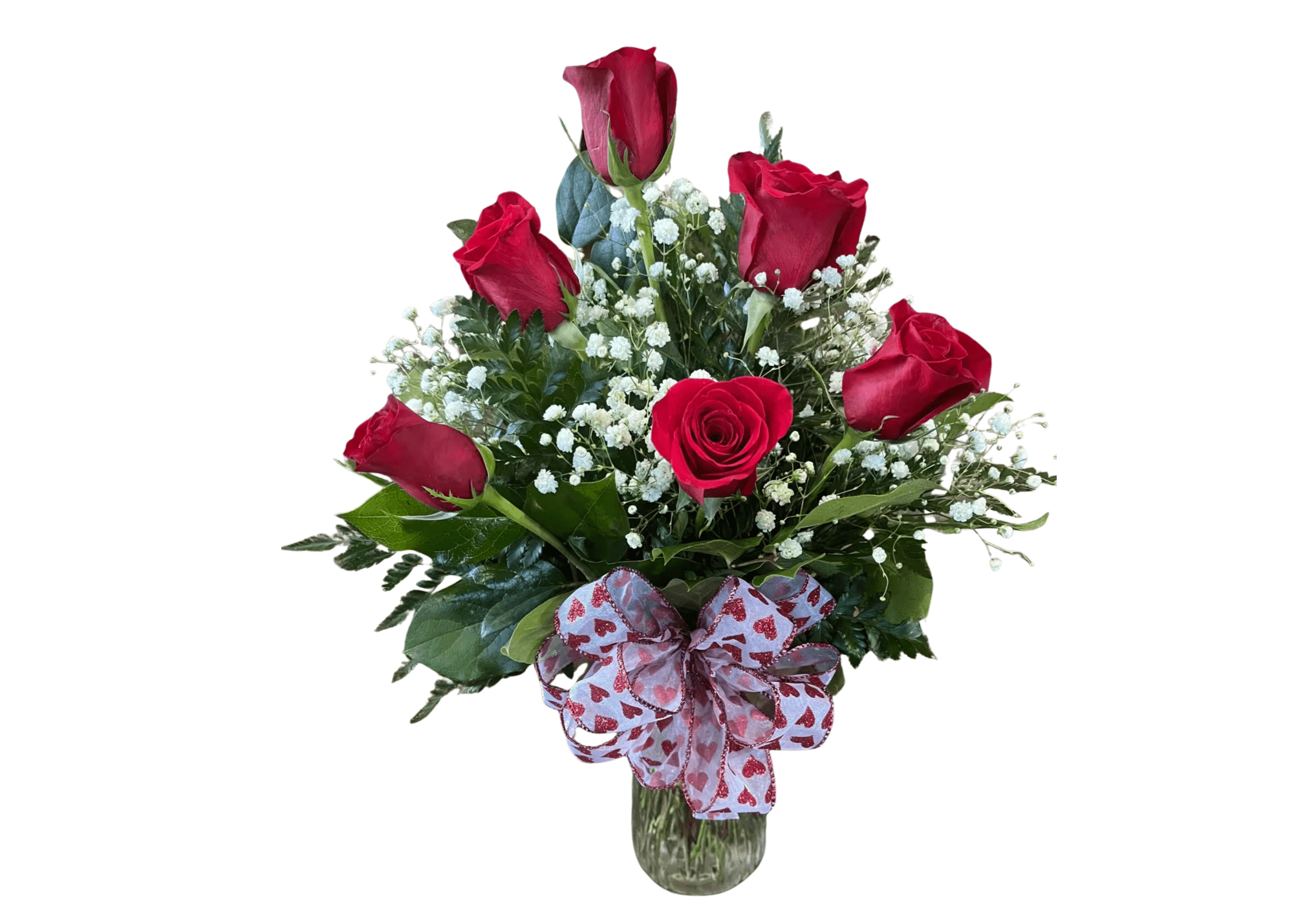 Arrangement of red roses and white filler flowers in a glass vase with a heart-pattern bow