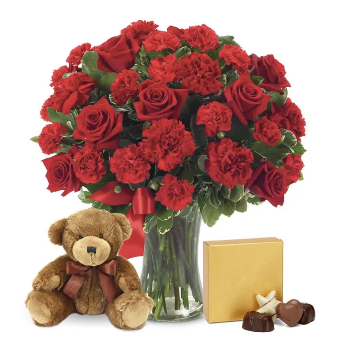 Red rose and carnation bouquet in a glass vase with a teddy bear and chocolates