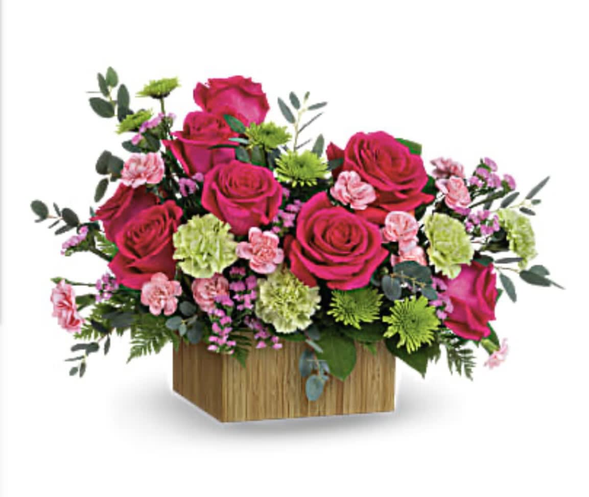 Pink roses and carnations in a wooden box