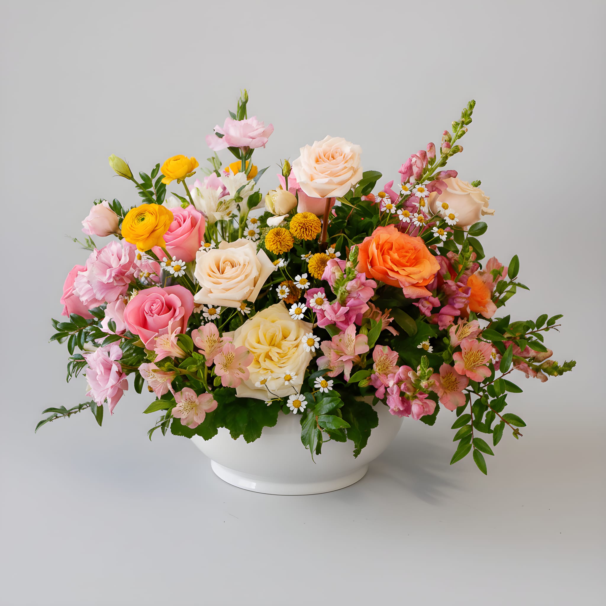 Free Spirit - Free Spirit is a vibrant garden-inspired arrangement designed in a luminous palette of soft pink, butter yellow, warm peach, and creamy ivory. Featuring premium roses, ranunculus, lisianthus, snapdragons, seasonal accent blooms, and lush greenery, this arrangement offers rich texture, natural movement, and joyful sophistication. Styled in a modern white ceramic bowl, it makes a stunning statement for birthdays, celebrations, thank-you gifts, or elevated everyday moments.  Handcrafted by our floral designers in West Los Angeles, Free Spirit is available for flower delivery throughout Santa Monica, Beverly Hills, Brentwood, Westwood, Pacific Palisades, Culver City, and surrounding Los Angeles neighborhoods. A perfect choice for those who love garden-style florals, layered color palettes, and refined LA design.