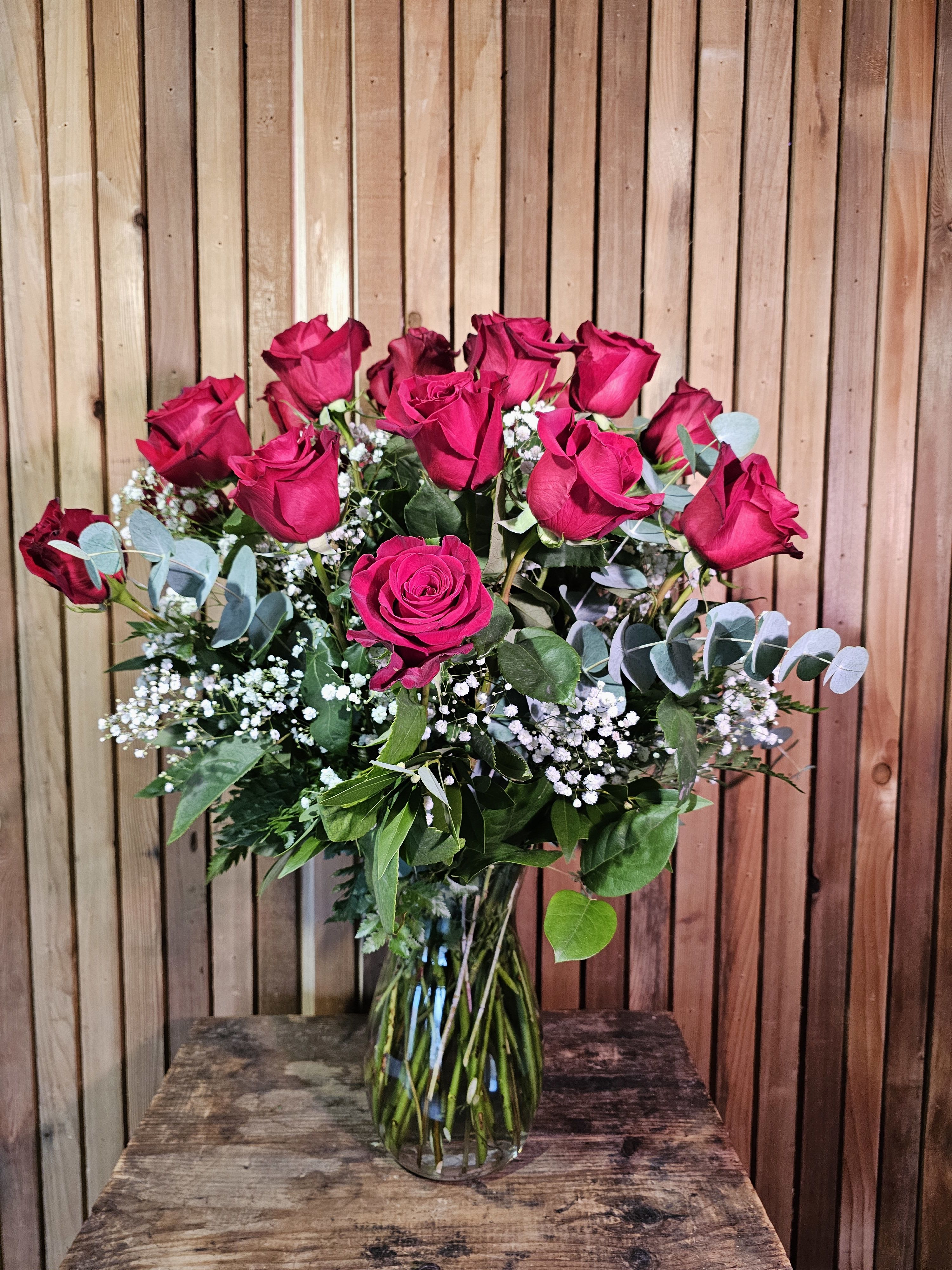 Bouquet of hot pink roses in a clear glass vase