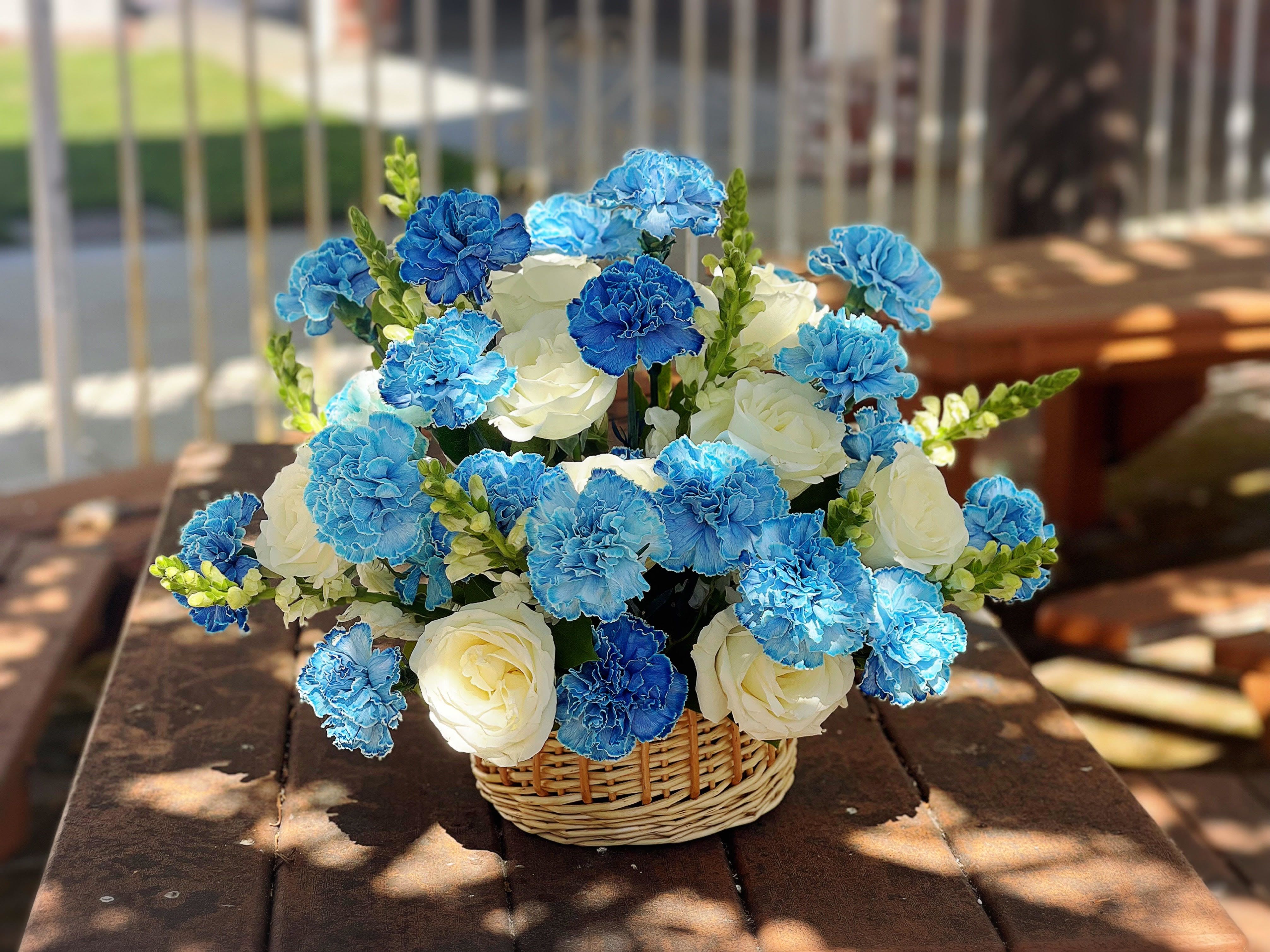 Basket Roses and Carnations ( Blue and White) - - 12 White Roses - 12 Blue Carnations - 10 White Snapdragons  - 8 Inches Basket