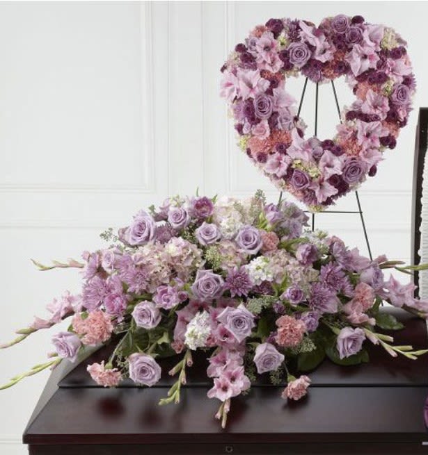 Lavender floral heart wreath on an easel above a matching flower spray