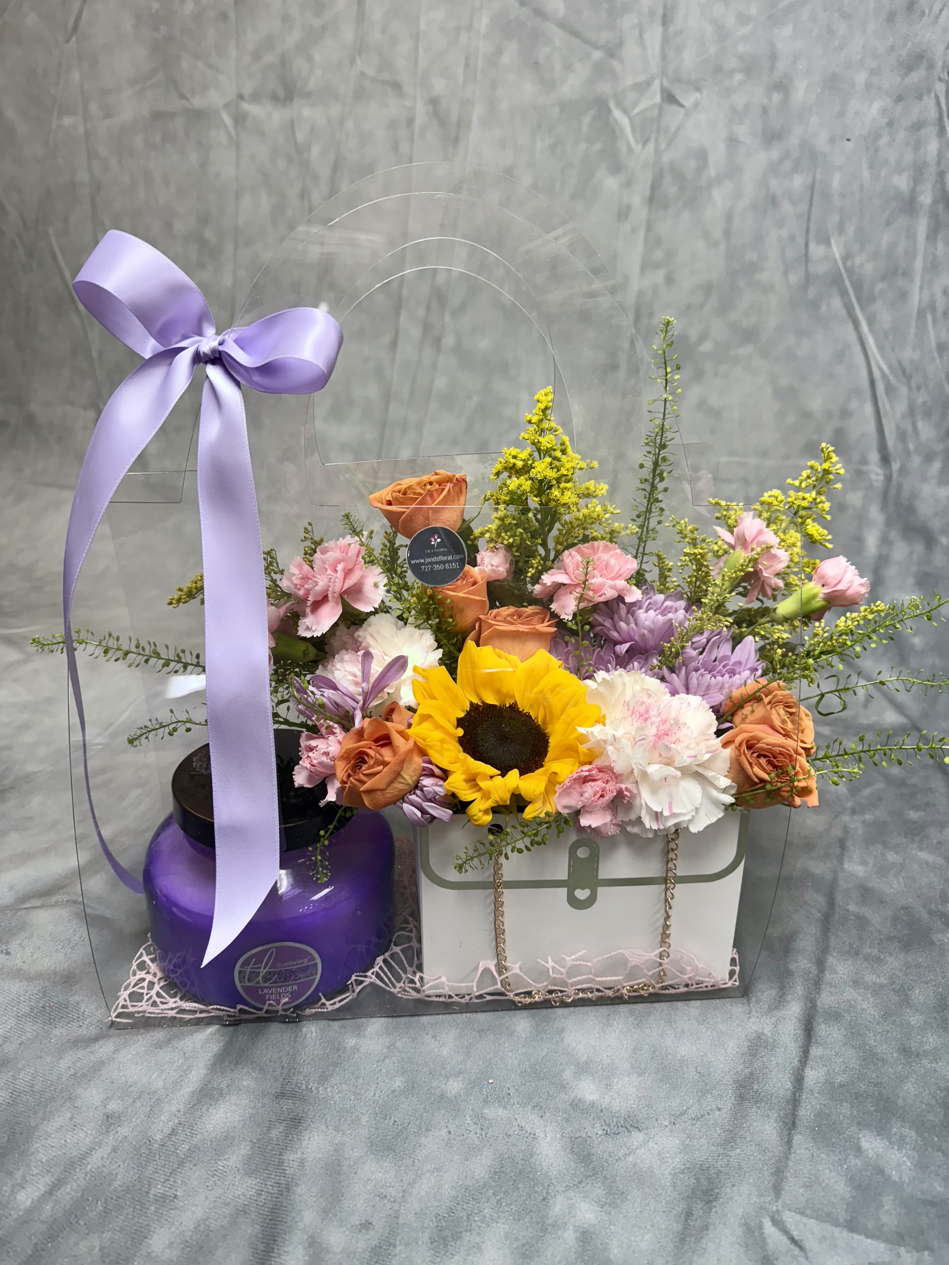 Flower gift set with sunflowers, roses, and carnations in a clear bag