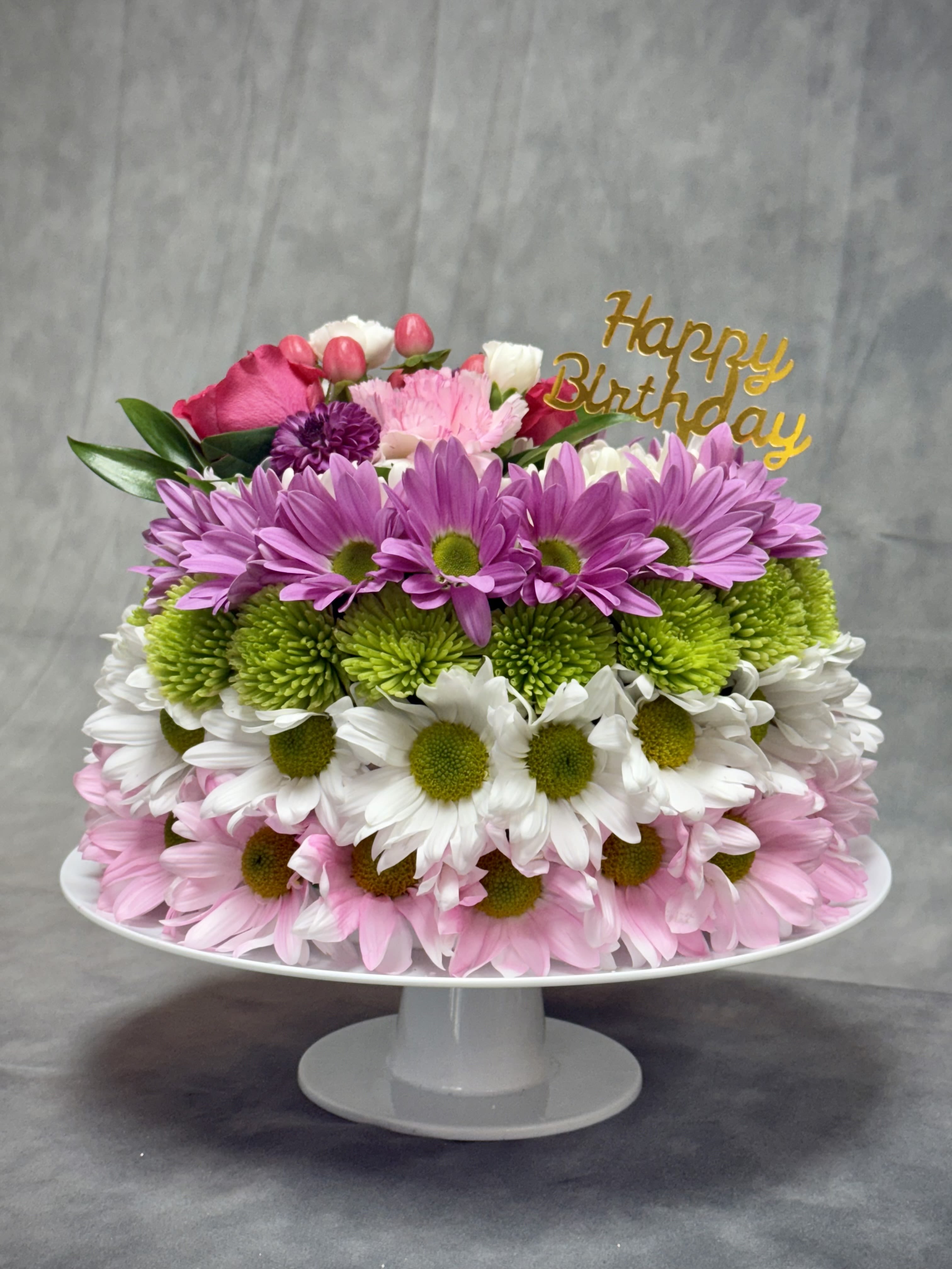 Tiered daisy arrangement with a Happy Birthday topper