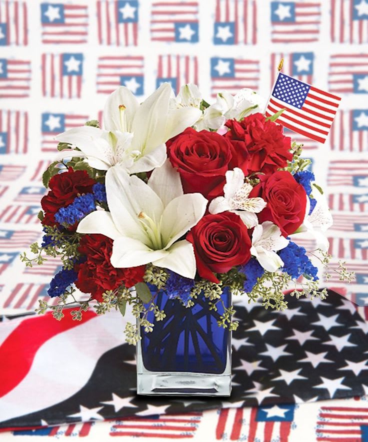 Patriotic Tribute  - Introducing our design Tribute! Beautifully arranged with lilies, roses , carnations, fillers and greenery in a beautiful square vase.