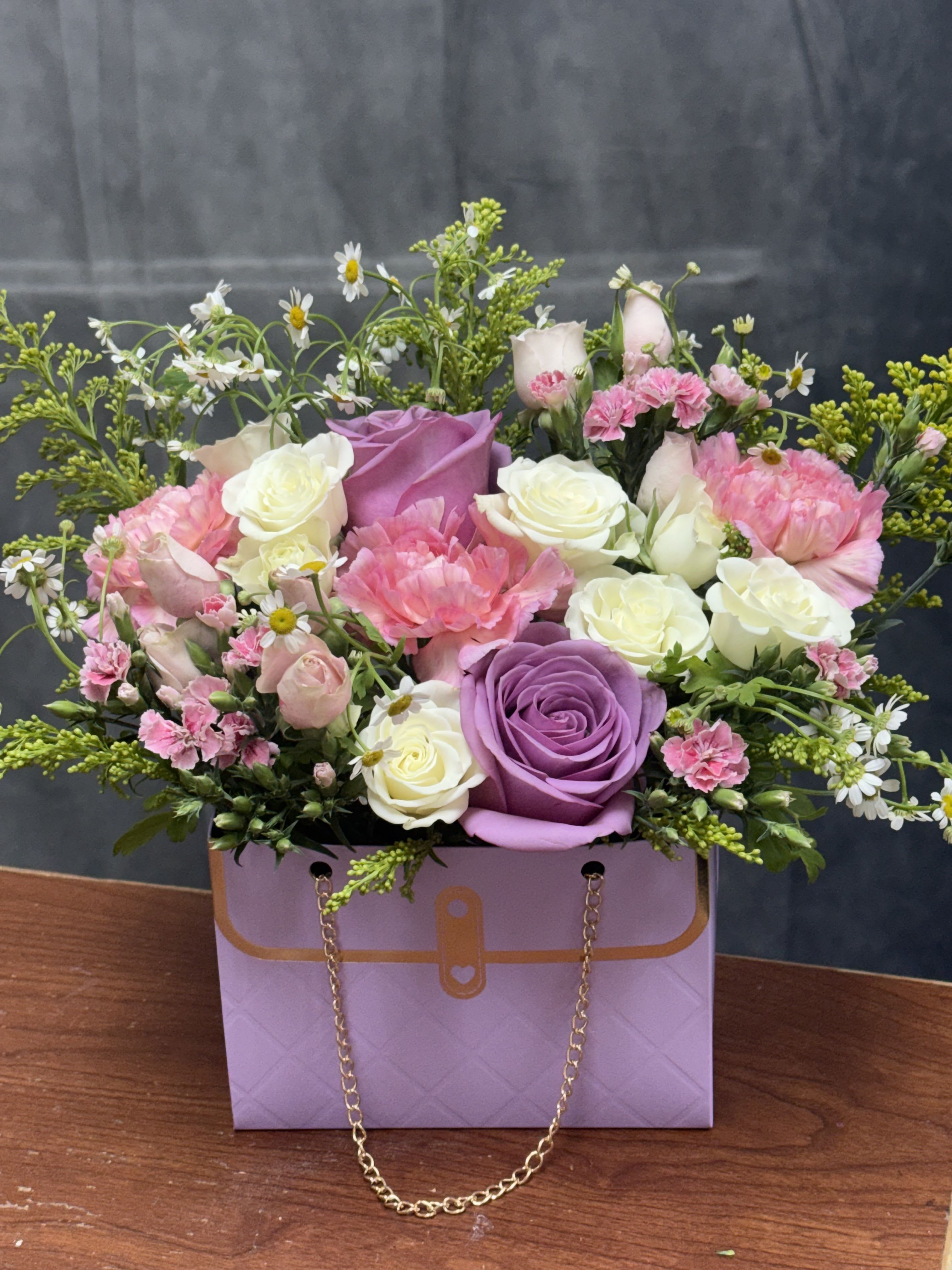 Lavender luxe Purse - Lavender luxe Purse is a charming gift arrangement in a purse-perfect as a birthday bouquet, anniversary arrangement, or a thoughtful Mother's Day surprise. The soft pinks, creamy whites, and lavenders perfect for any occasion 