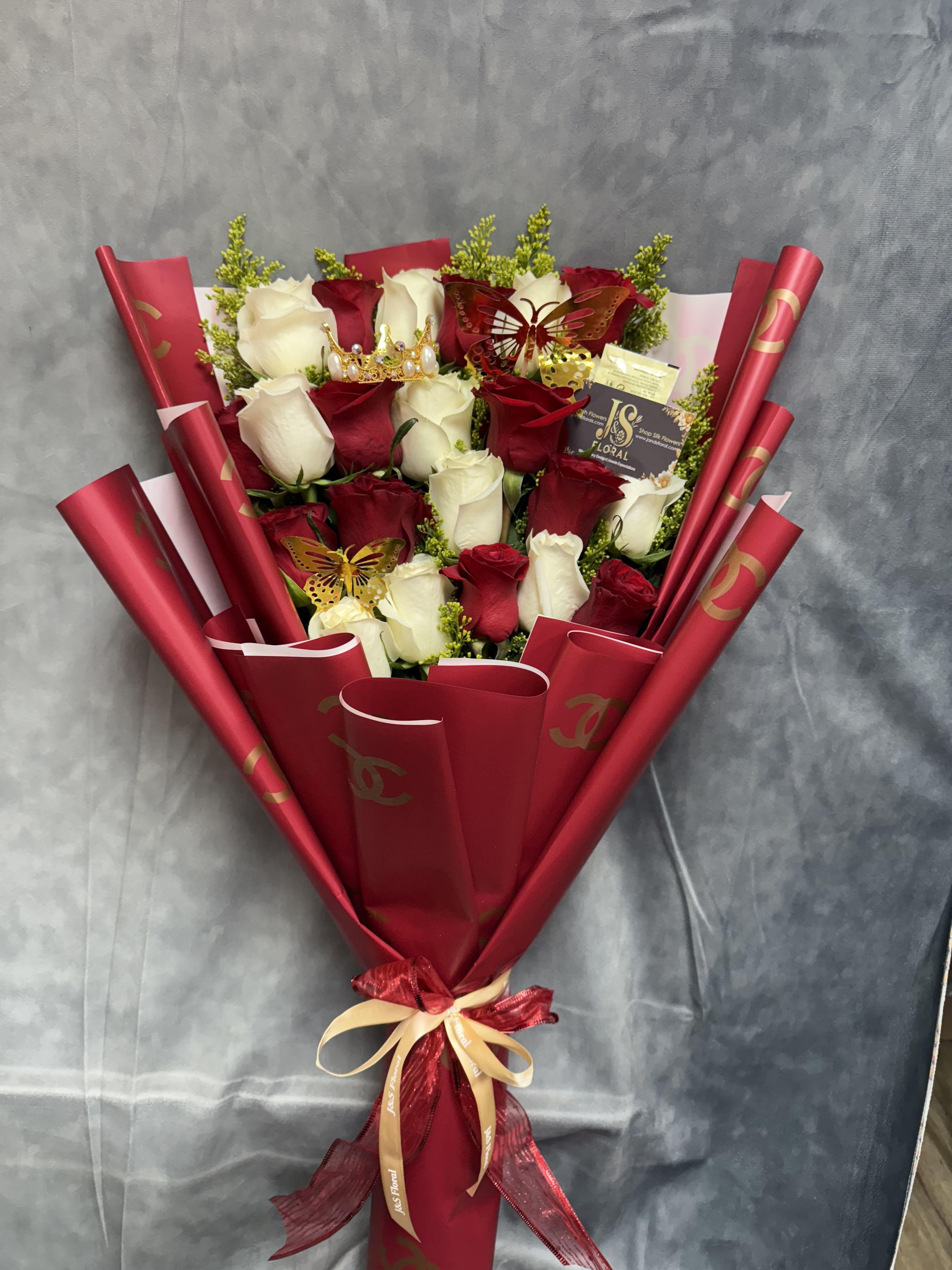 Bouquet of red and white roses wrapped in red paper