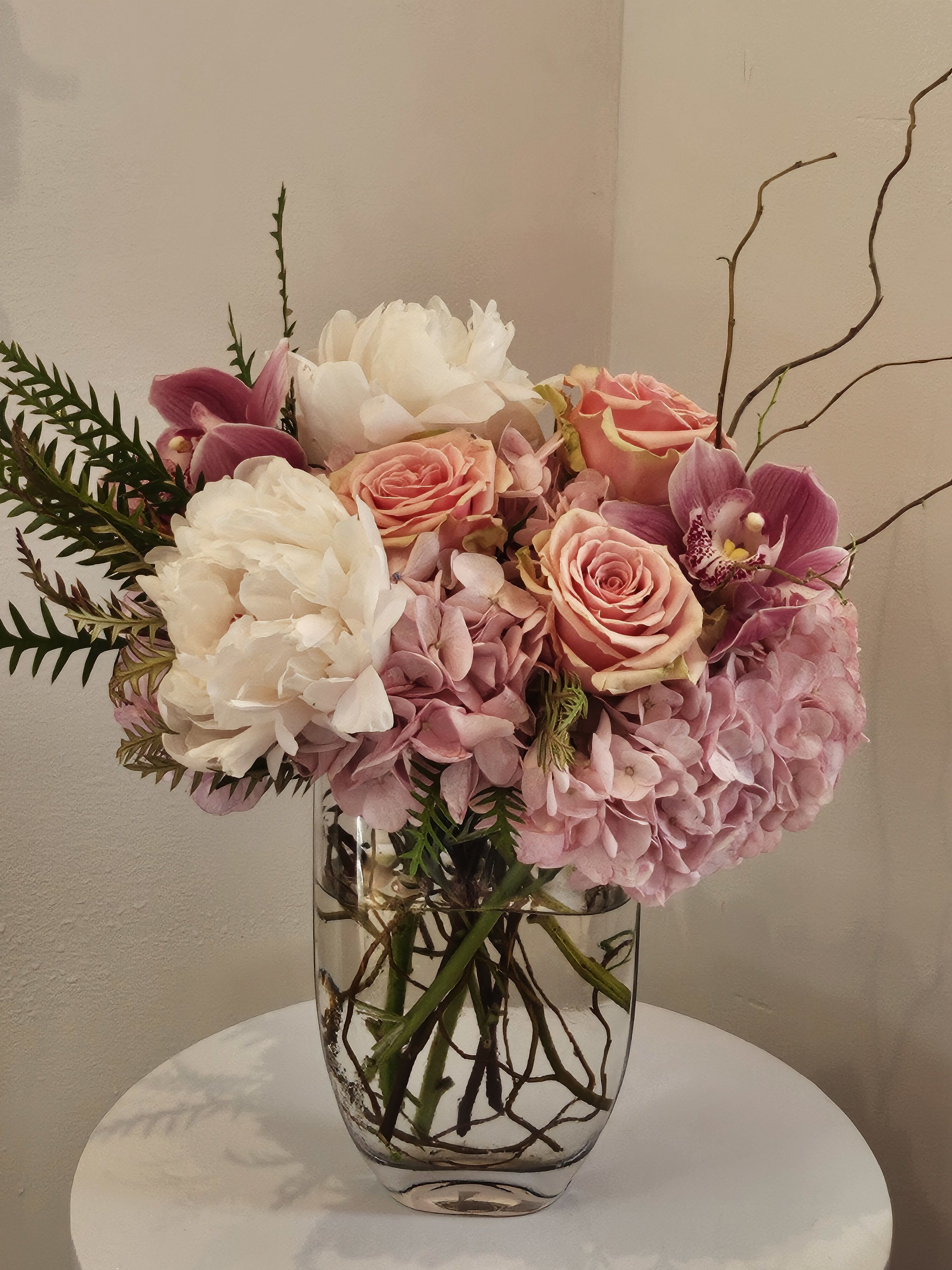 Pink and white floral arrangement in a clear glass vase