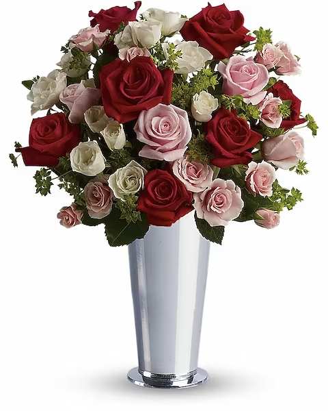 Bouquet of red, pink, and white roses in a tall silver vase