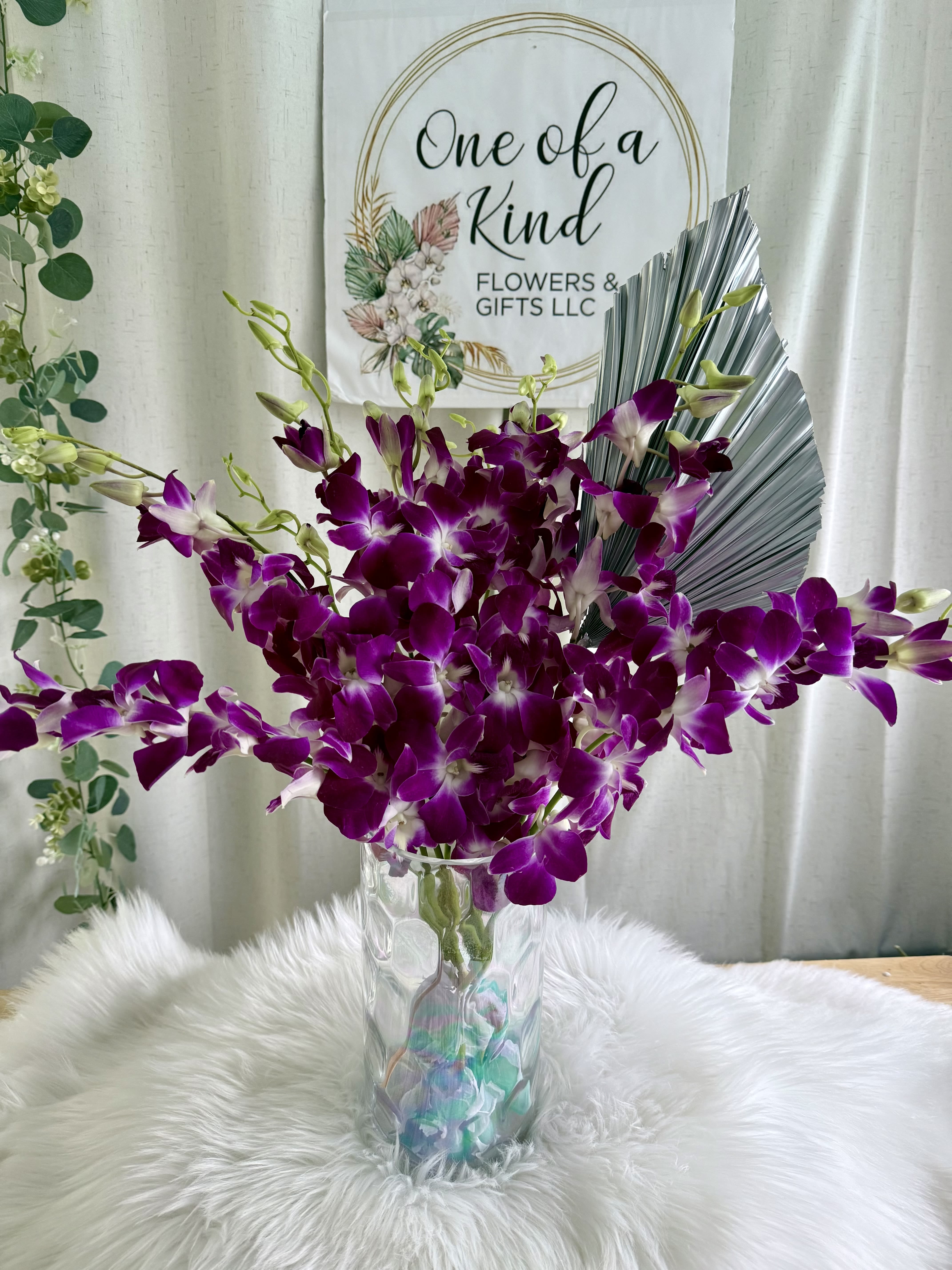 Enchanted Orchid Dreams - A dreamy arrangement of lush purple orchids with soft white accents, designed to evoke romance and elegance. Perfect for heartfelt gifts, anniversaries, or simply to brighten someone’s day with beauty and charm.
