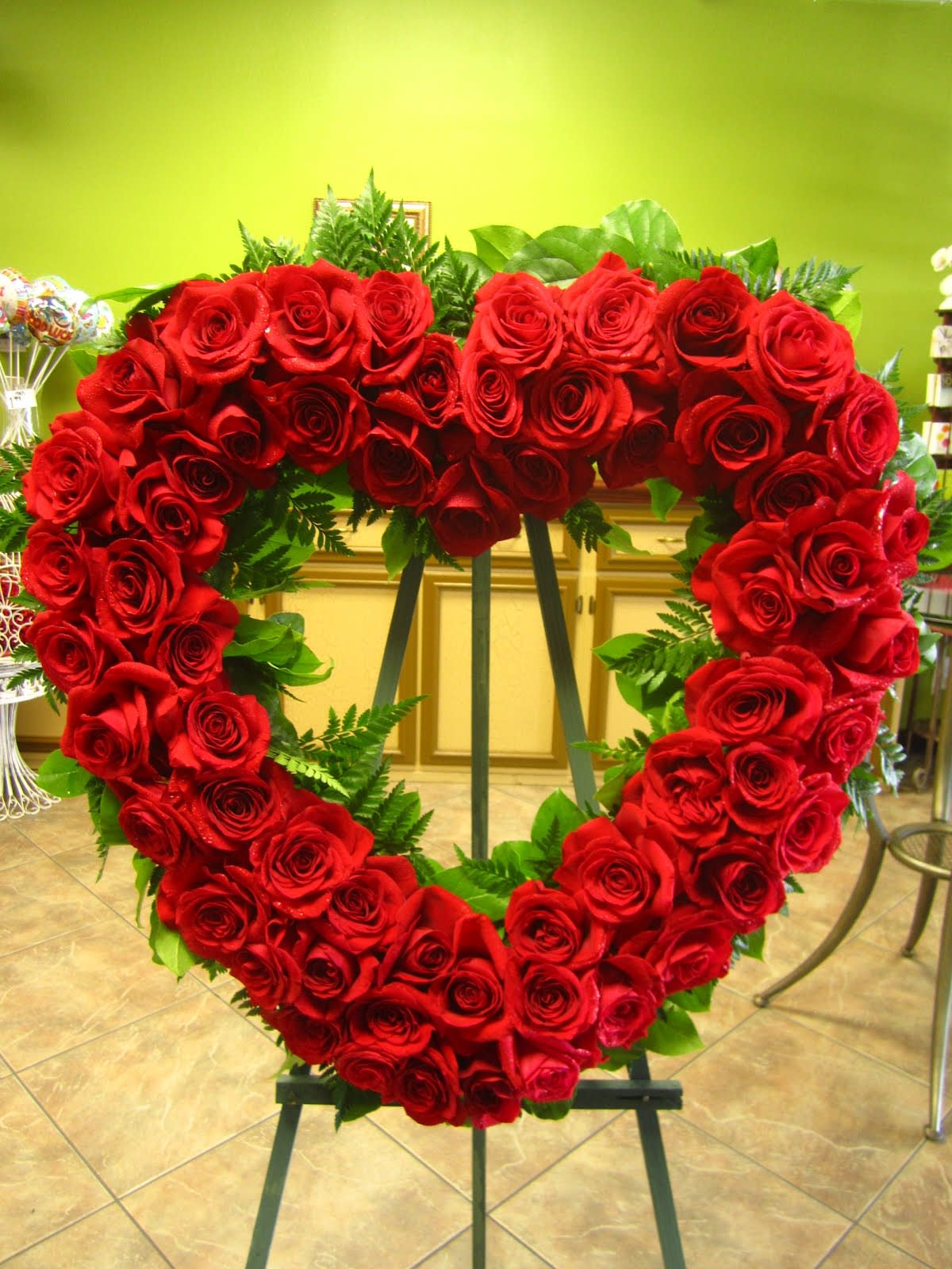 Heart-shaped red rose standing spray on an easel