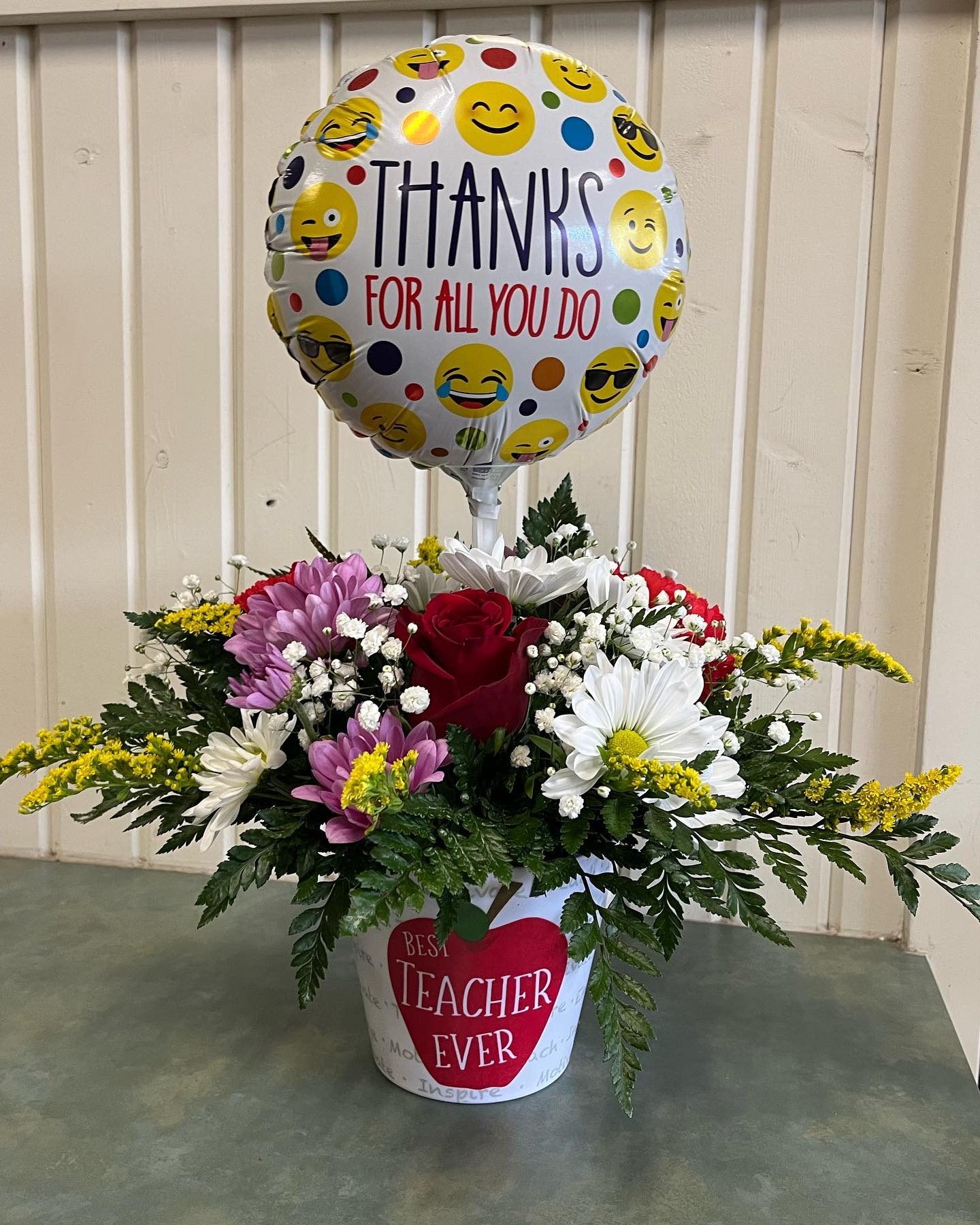 Mixed flower arrangement in a pot with a thank-you balloon and teacher message
