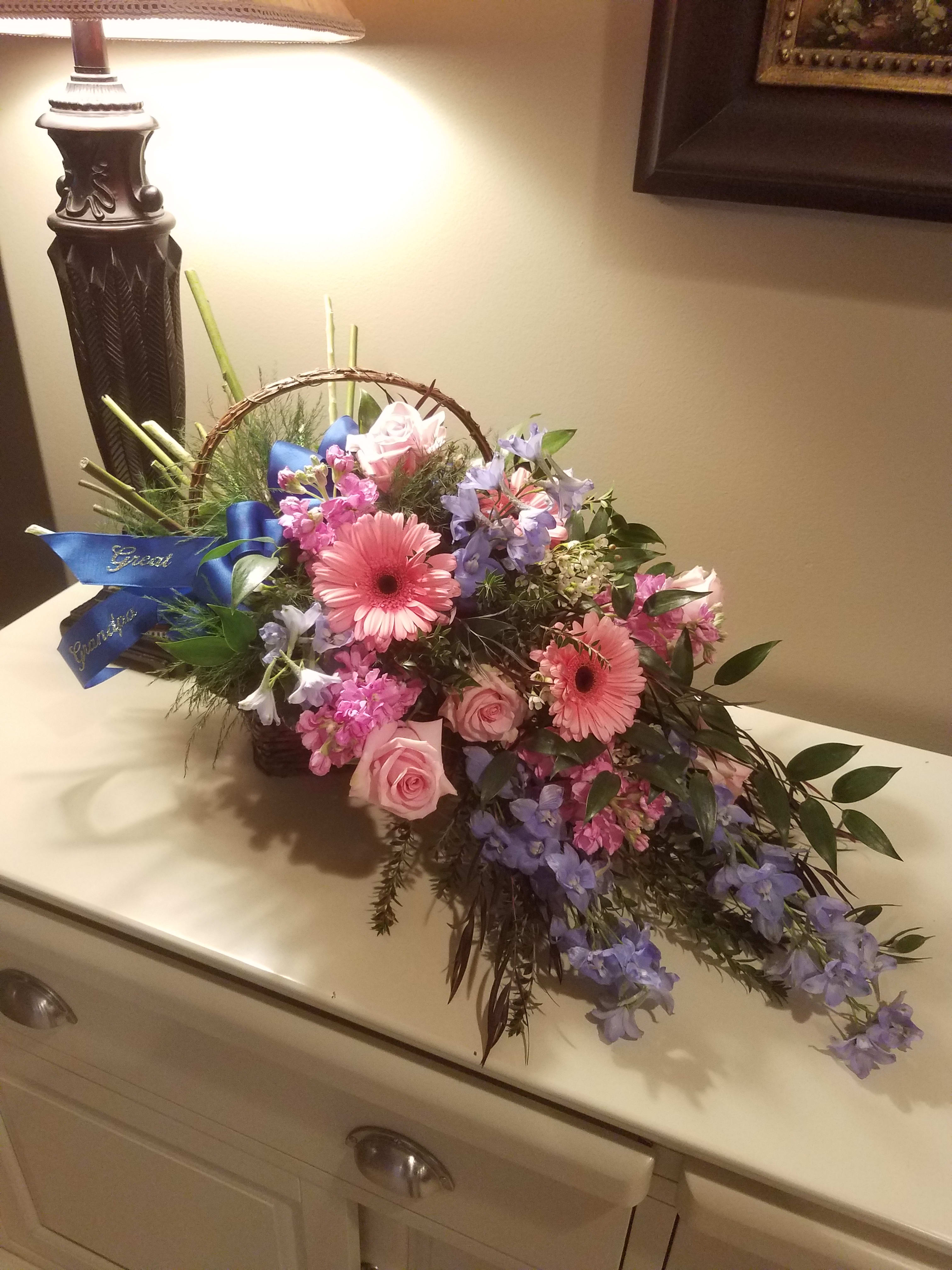 Basket Sympathy Bouquet  - A natural basket filled with lush flowers designed as if a hand tied bouquet were set inside. A beautiful, natural styled arrangement that shows you care.