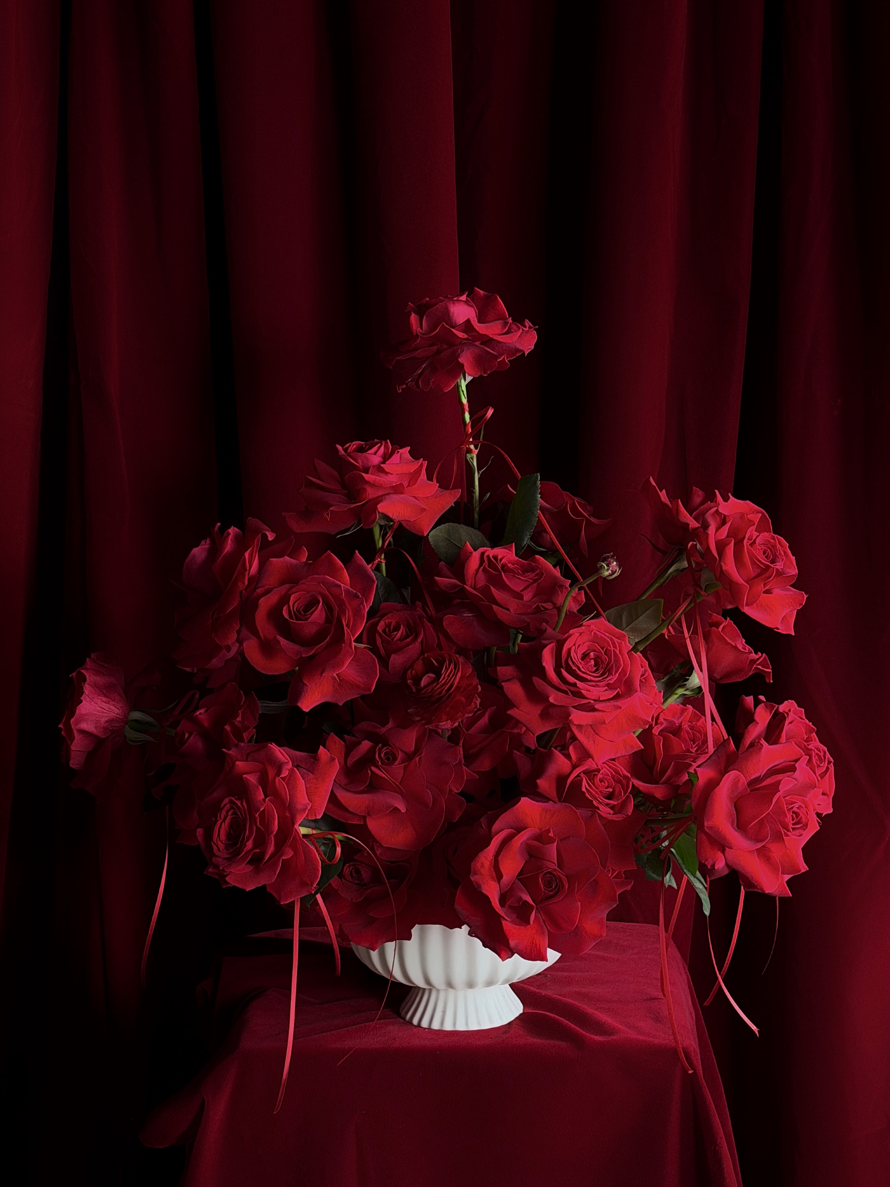 Hey Lover vase!  - Designed for falling in love. Layers of red roses and ranunculus, wrapped in pure Amor.