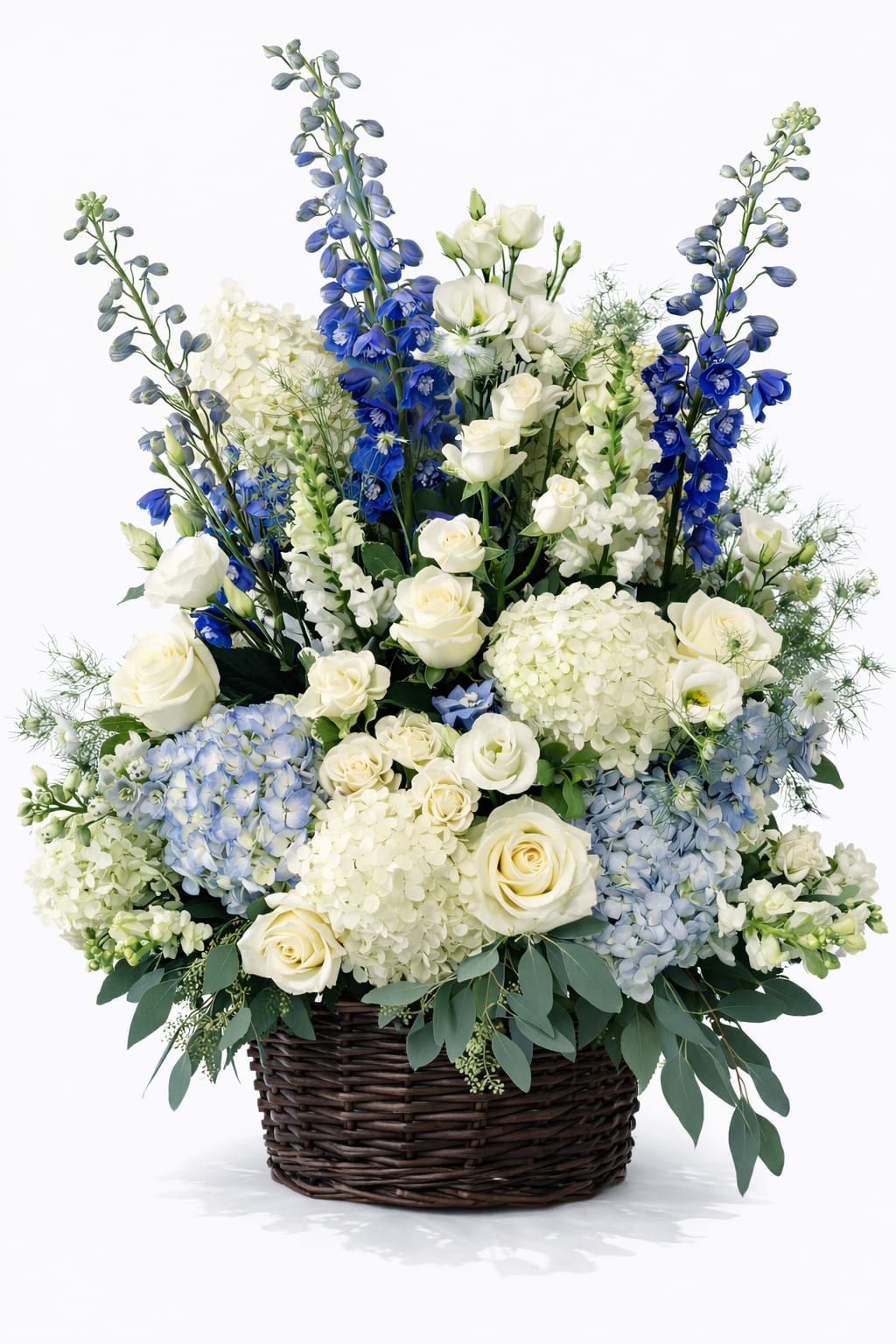 Blue and white floral arrangement in a wicker basket