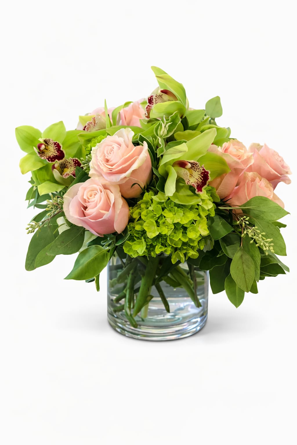 Pink roses and green orchids arranged in a glass vase