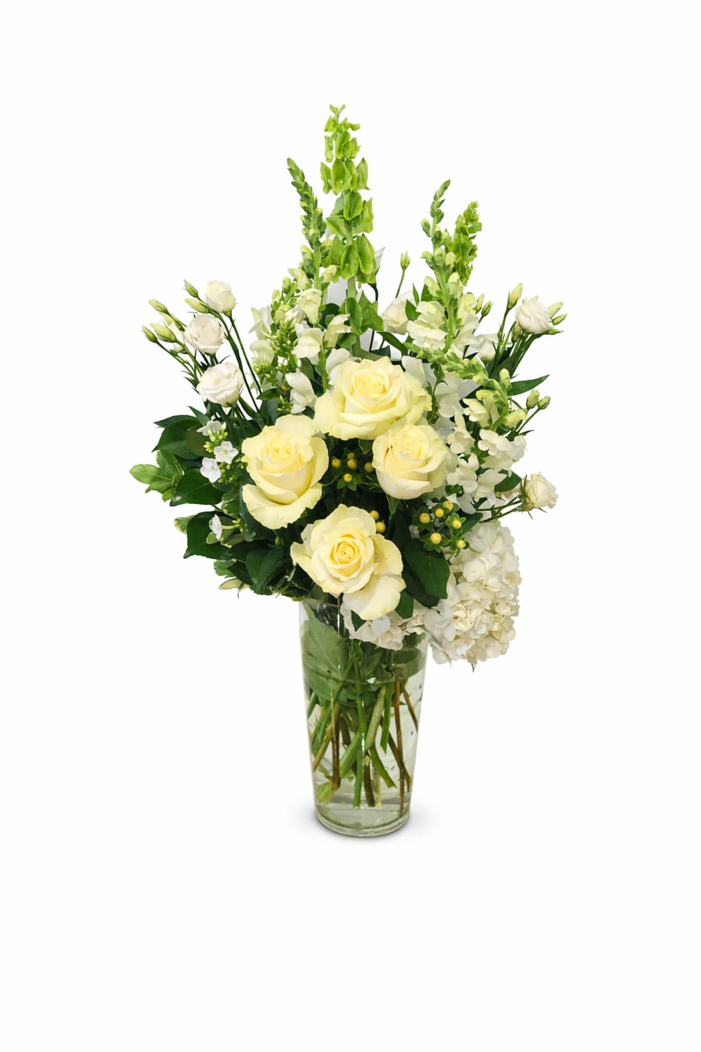 Cream roses and white flowers arranged in a clear glass vase